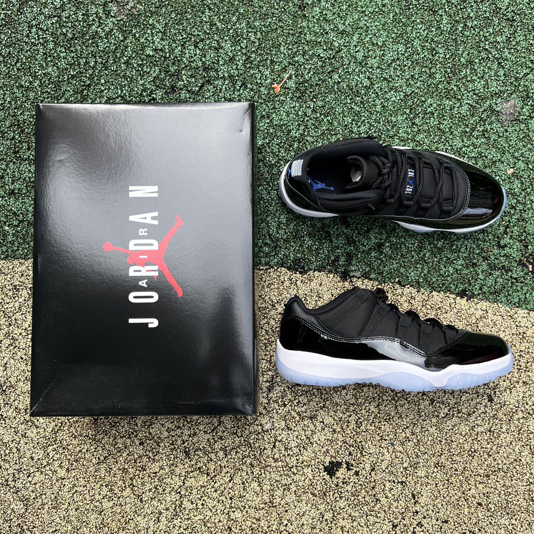 Nike Air Jordan 11 Retro Low Space Jam sneakers in black and blue with patent leather accents, featuring Jumpman logo details.