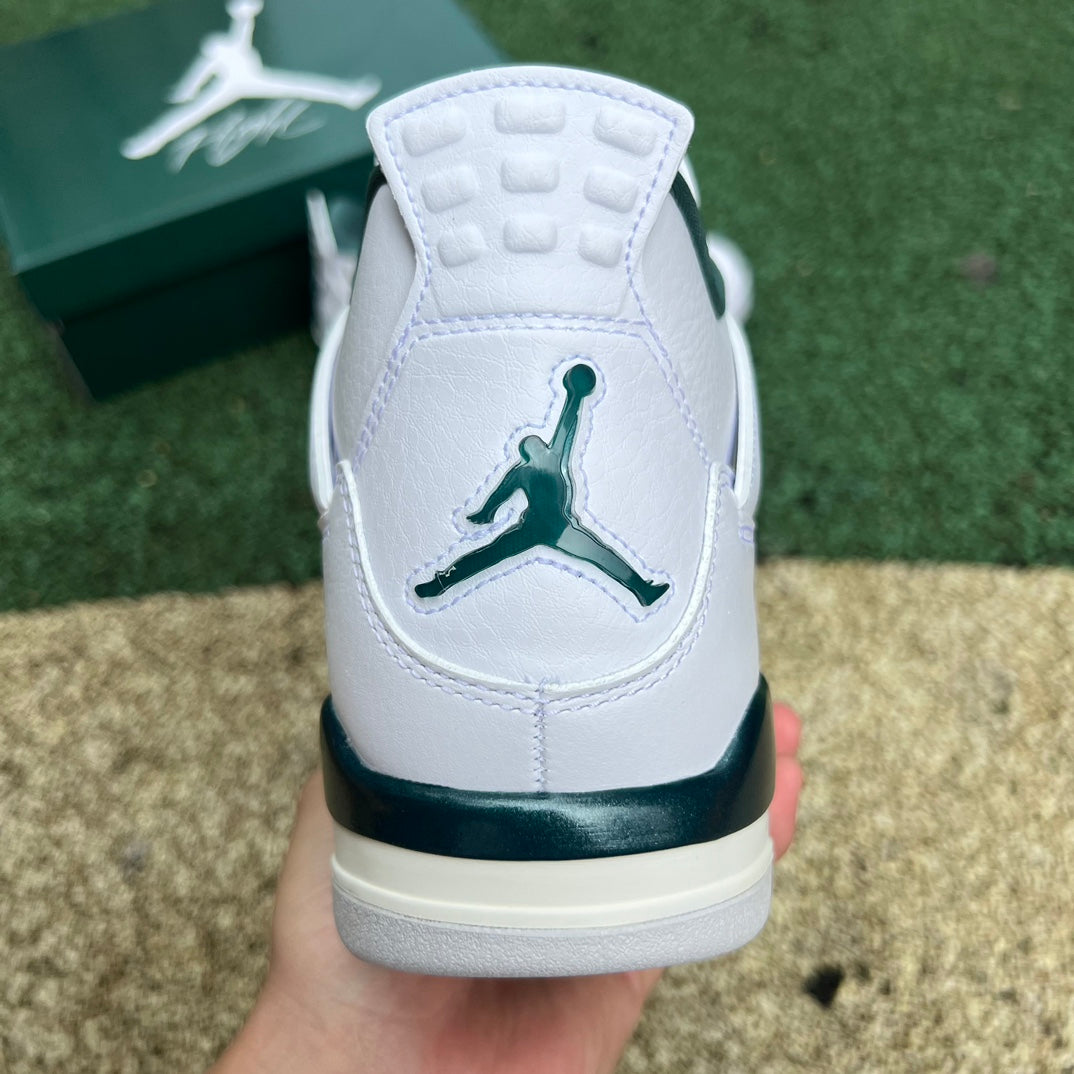 Nike Air Jordan 4 Retro Oxidized Green sneakers featuring a green and black colorway with classic design details.