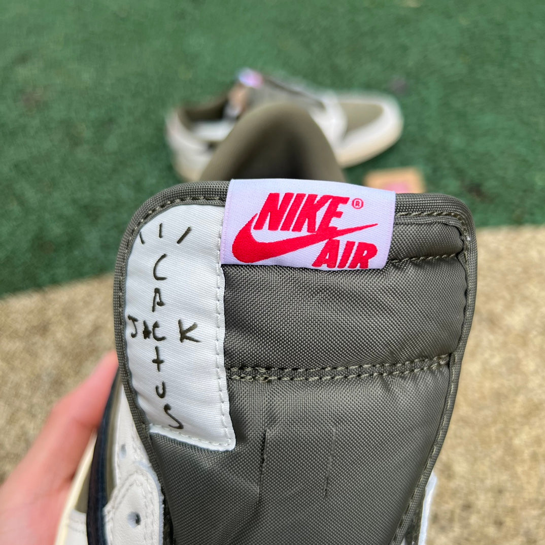 Nike Air Jordan 1 Retro Low OG SP Travis Scott sneakers in medium olive color with black accents and Nike Jordan branding.