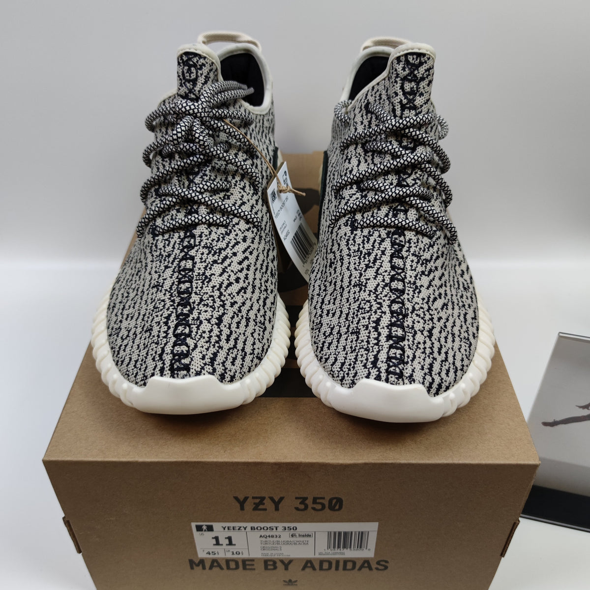 Nike x Jordan Yeezy Boost 350 Turtle Dove sneakers with tan and gray Primeknit upper and Boost sole detail.