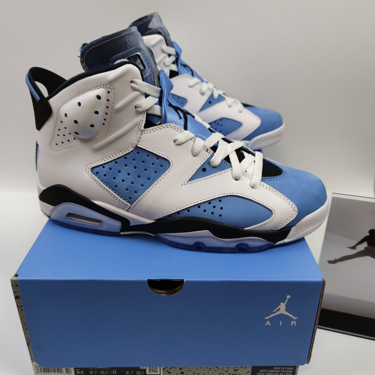 Nike Air Jordan 6 Retro University Blue sneakers in white and blue with black accents and a visible sole design.