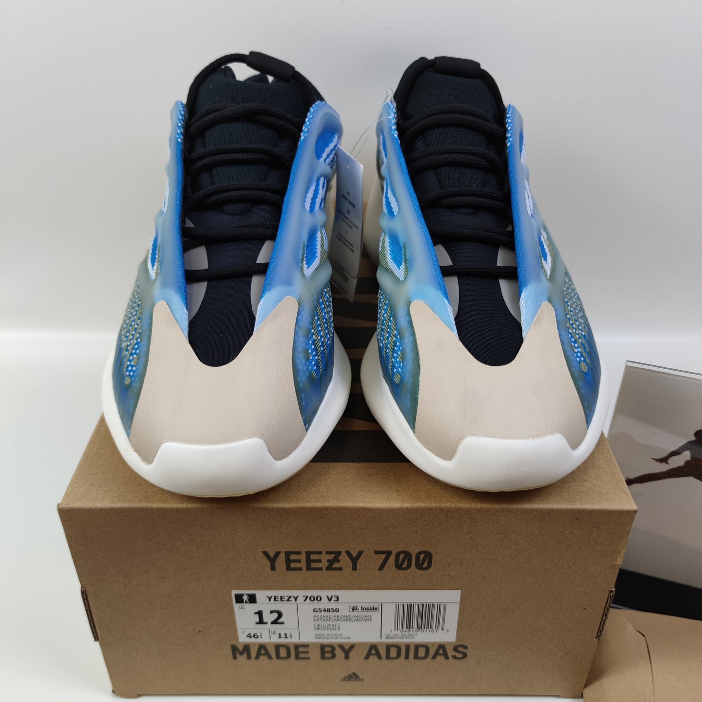 Adidas Originals Yeezy Boost 700 V3 Arzareth sneakers in gray with chunky design and textured upper, displayed on a plain background.