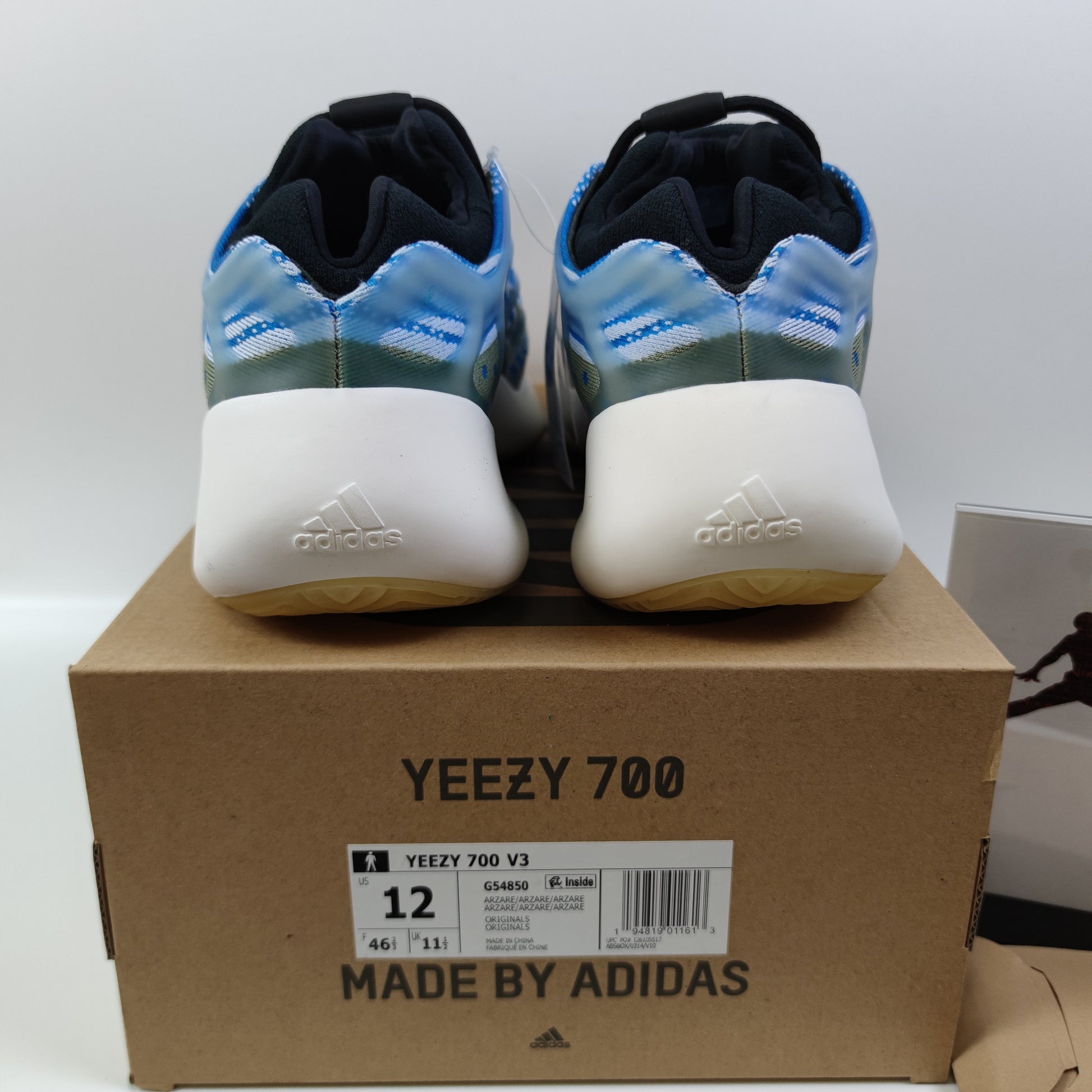 Adidas Originals Yeezy Boost 700 V3 Arzareth sneakers in gray with chunky design and Boost sole, displayed from a side angle.