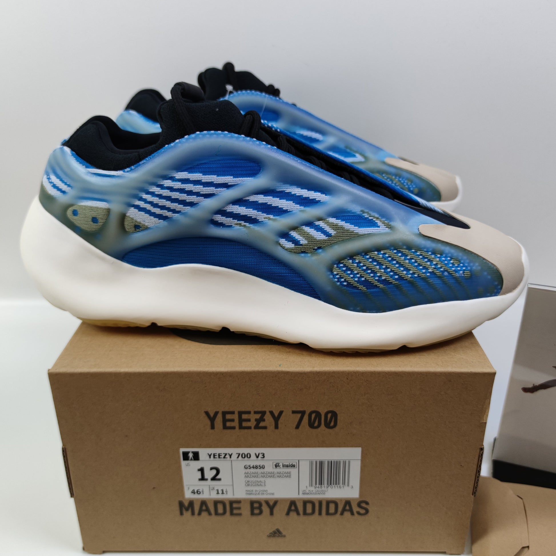 Adidas Originals Yeezy Boost 700 V3 Arzareth sneaker in gray with textured upper and chunky sole.