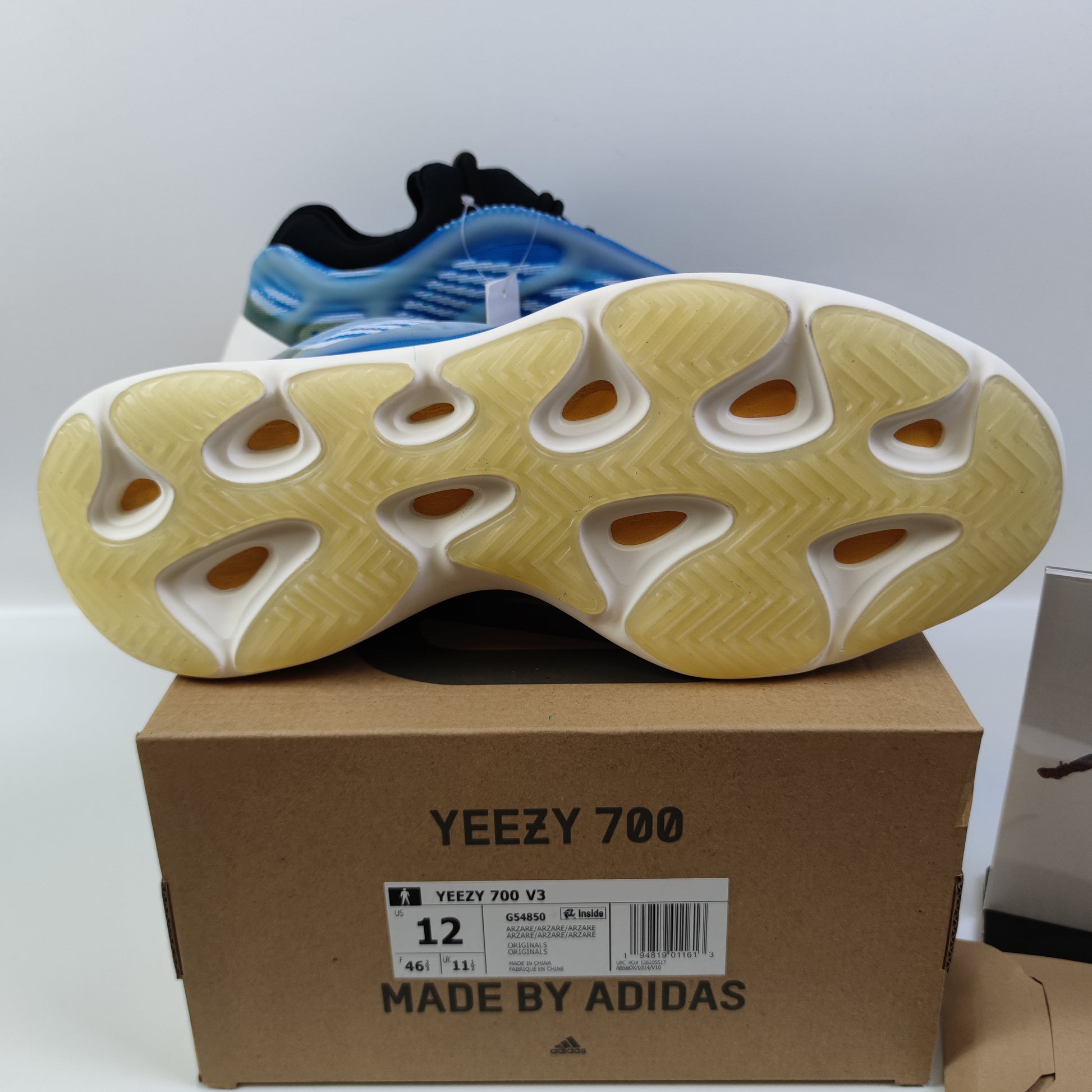 Adidas Originals Yeezy Boost 700 V3 Arzareth sneaker in gray with textured upper and chunky sole, displayed from side angle
