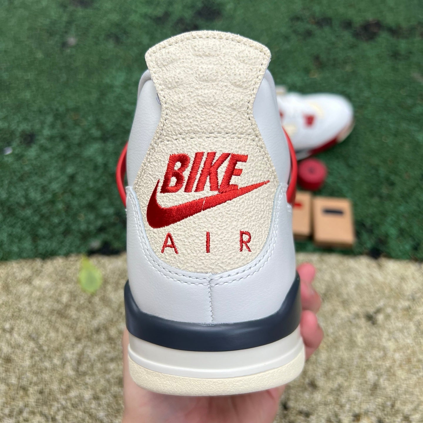 Nike Jordan 4 Retro OG Nigel Sylvester Brick sneakers featuring a classic design and vibrant brick-inspired colorway.