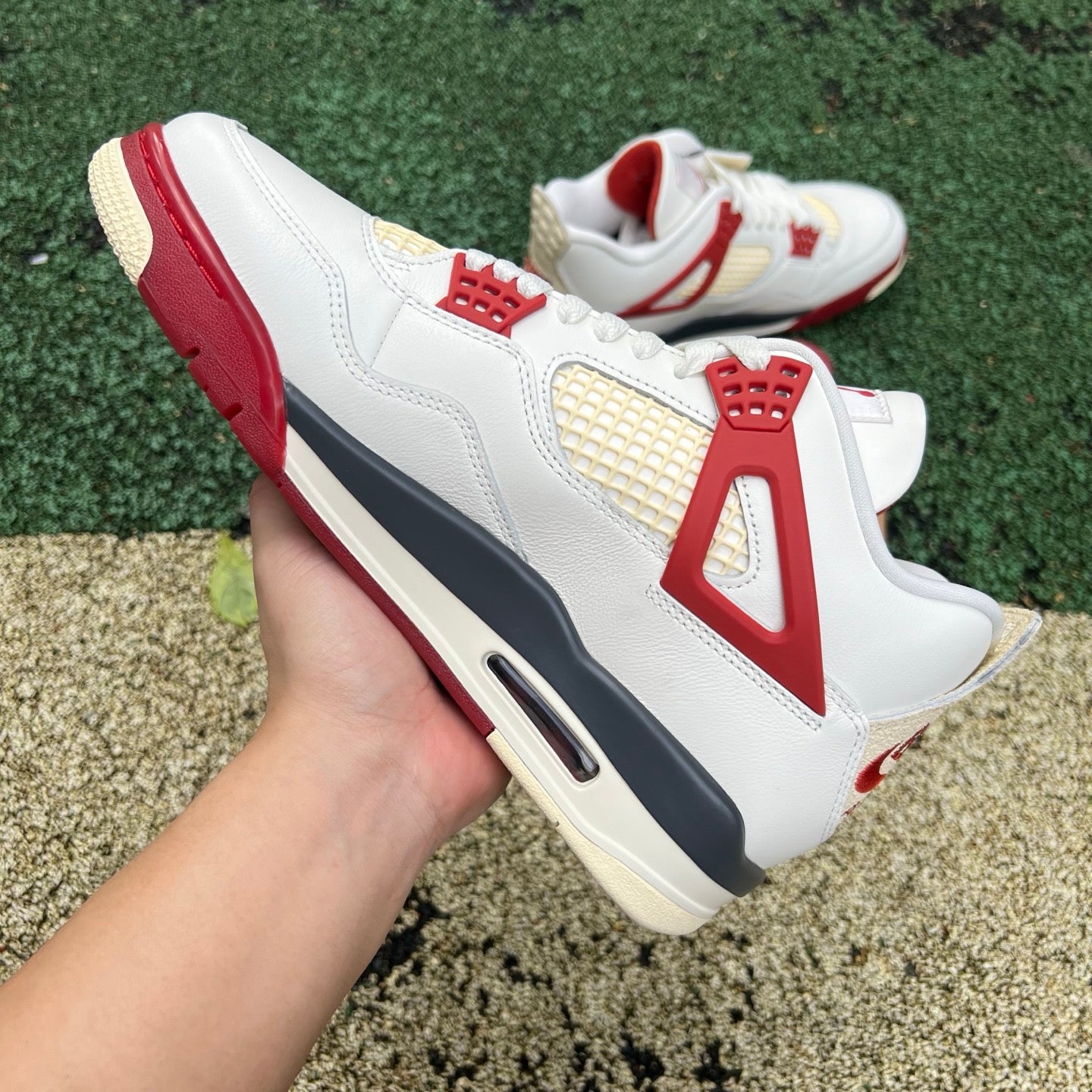 Nike Jordan 4 Retro OG Nigel Sylvester Brick sneakers, side view showcasing the iconic design and vibrant brick colorway.