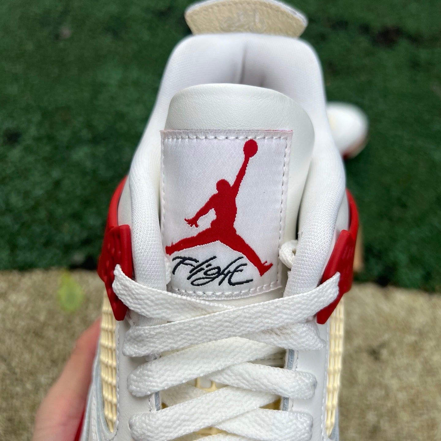 Nike Jordan 4 Retro OG Nigel Sylvester Brick sneakers in white and red leather with black accents and a classic design.