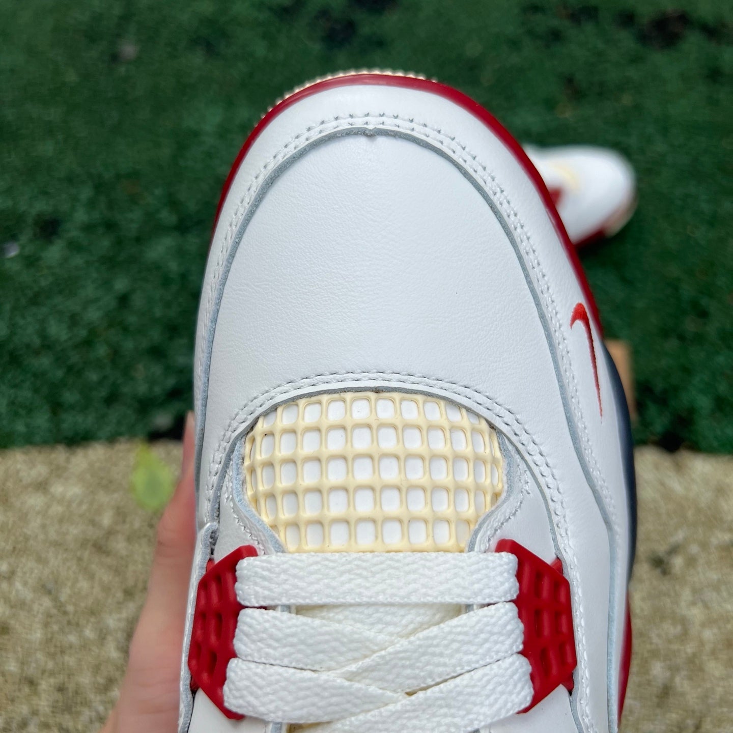Nike Jordan 4 Retro OG Nigel Sylvester Brick sneakers, side view showing red brick colorway and classic design details.