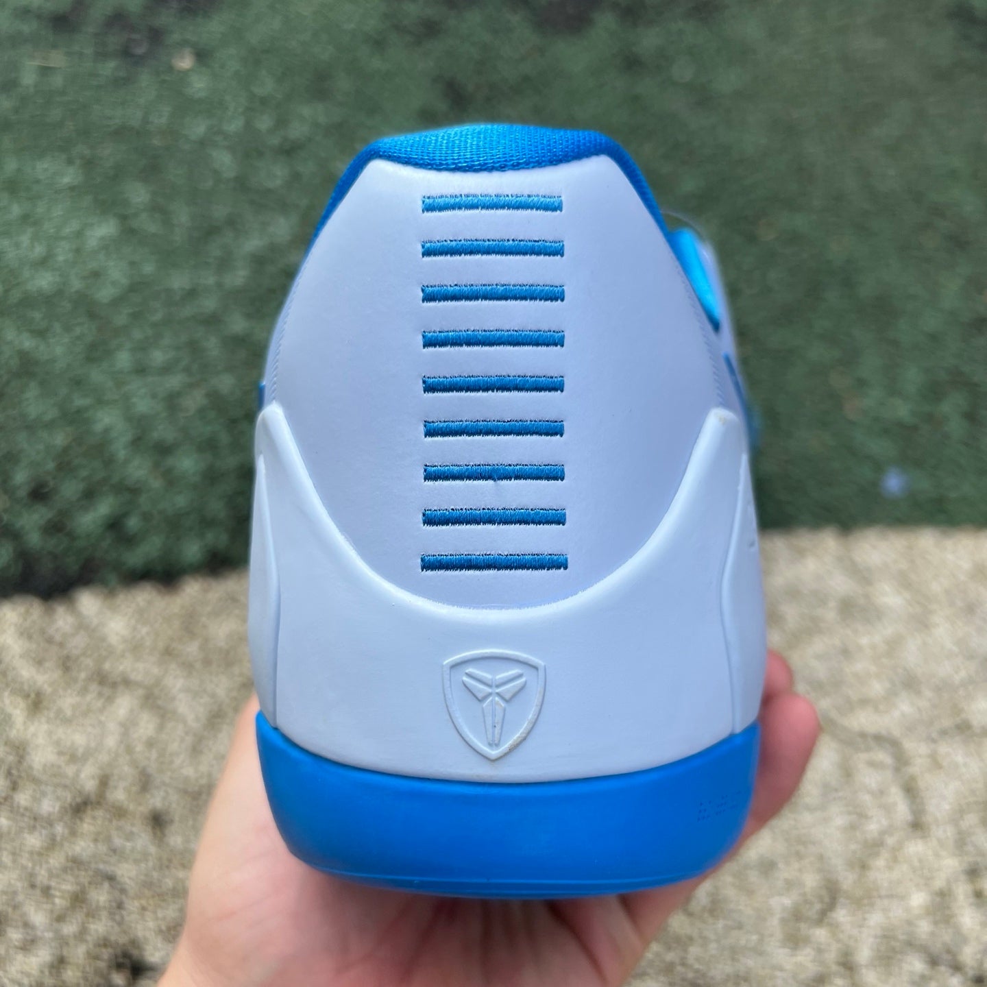 Nike Kobe 9 EM Low Protro TB Hydrogen Blue basketball sneakers with blue and black accents, featuring Nike x Jordan branding.