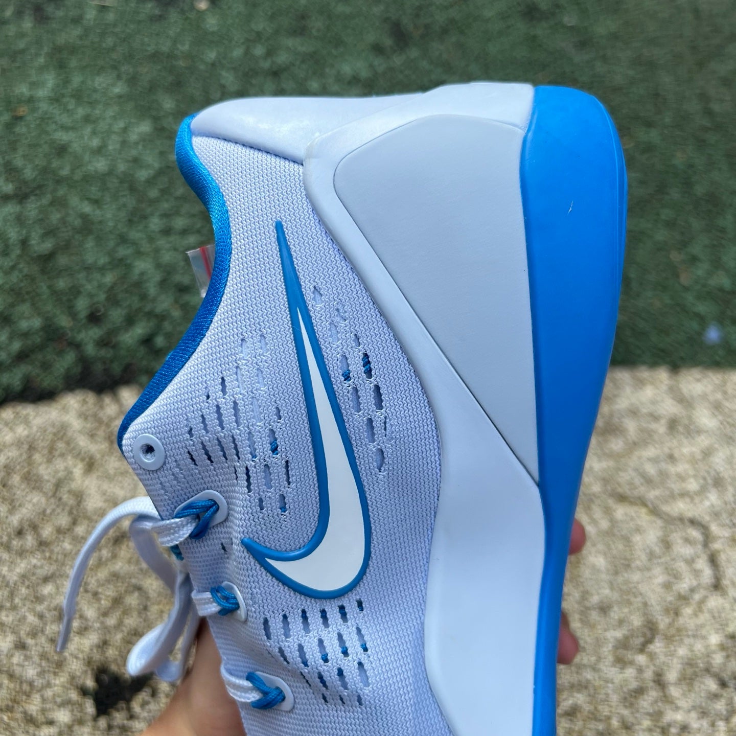 Nike Kobe 9 EM Low Protro basketball shoes in hydrogen blue with black accents, featuring sleek low-top design and Nike branding.