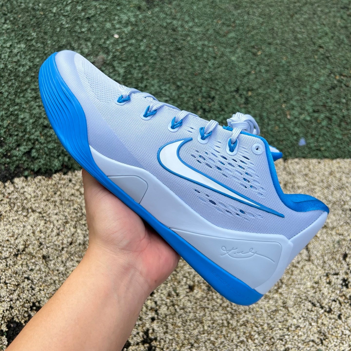 Nike Kobe 9 EM Low Protro TB hydrogen blue basketball shoes with Nike x Jordan branding and sleek low-profile design