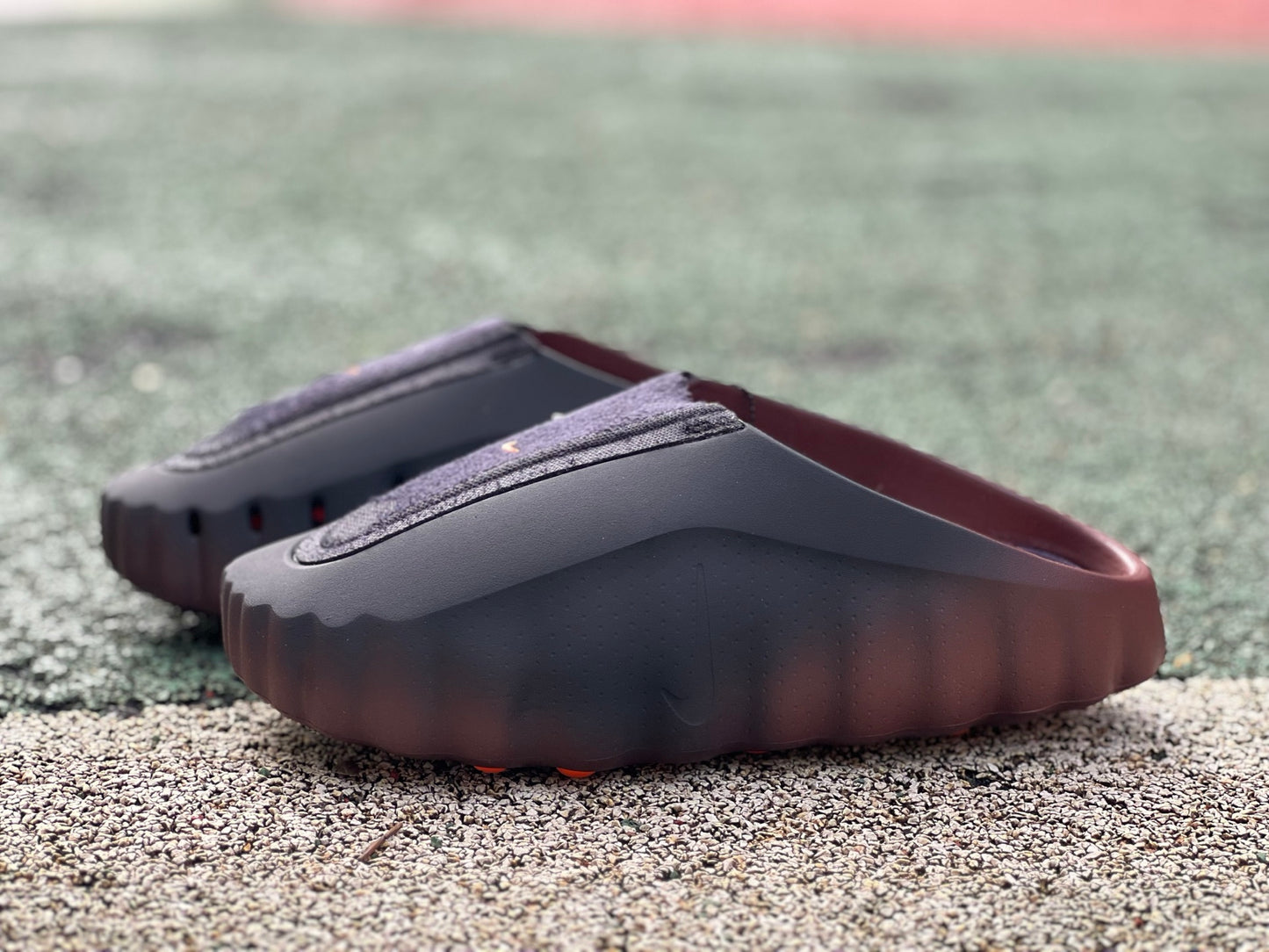 Nike x Jordan Mind 001 Flyknit Slide in bronze eclipse and total orange, featuring a sleek slip-on design with breathable Flyknit material.