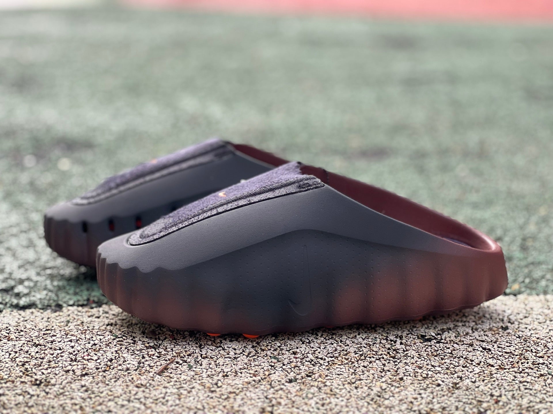 Nike x Jordan Mind 001 Flyknit Slide in bronze eclipse and total orange, featuring a sleek slip-on design with breathable Flyknit material.