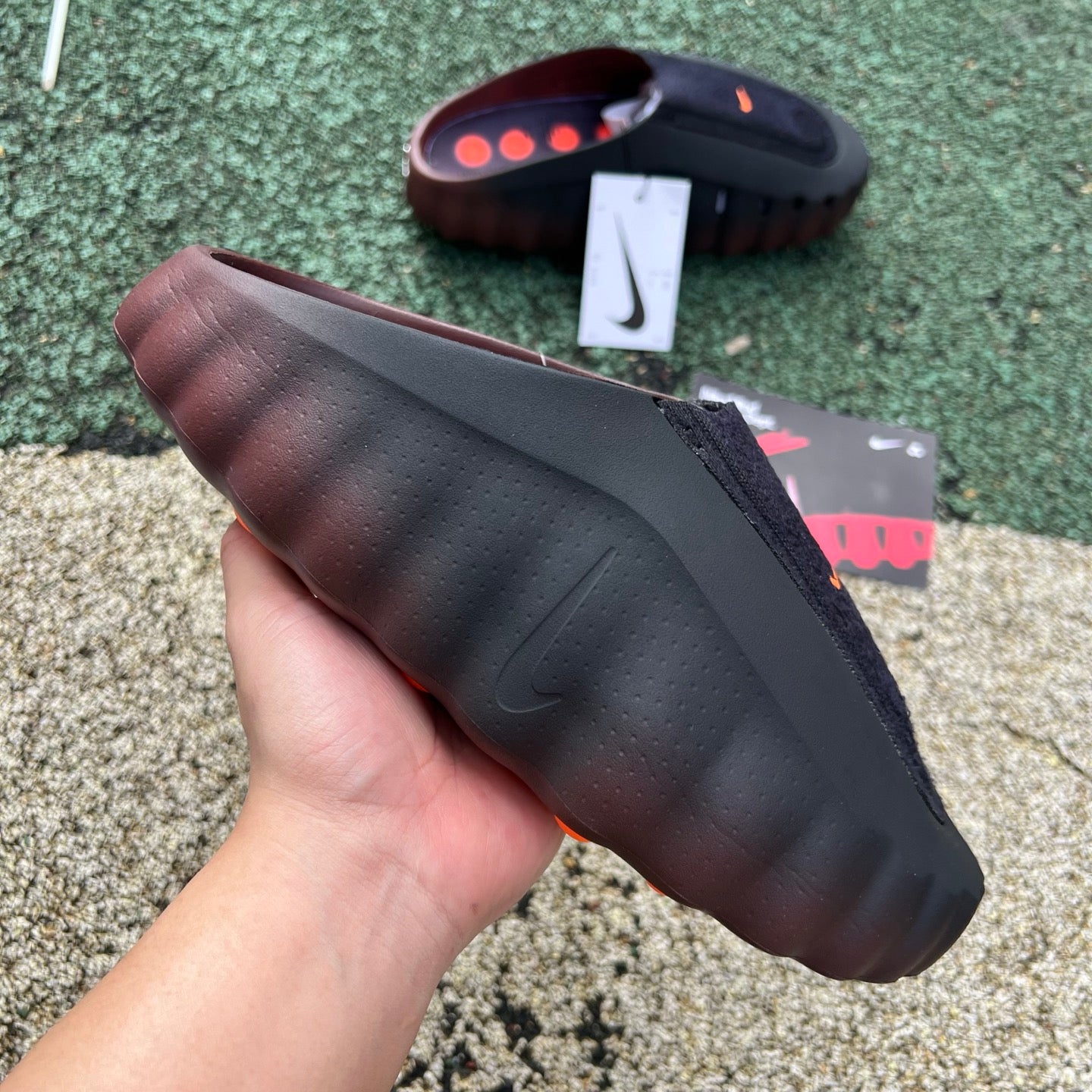 Nike x Jordan Mind 001 Flyknit slide in bronze eclipse and total orange, featuring a lightweight, breathable design.