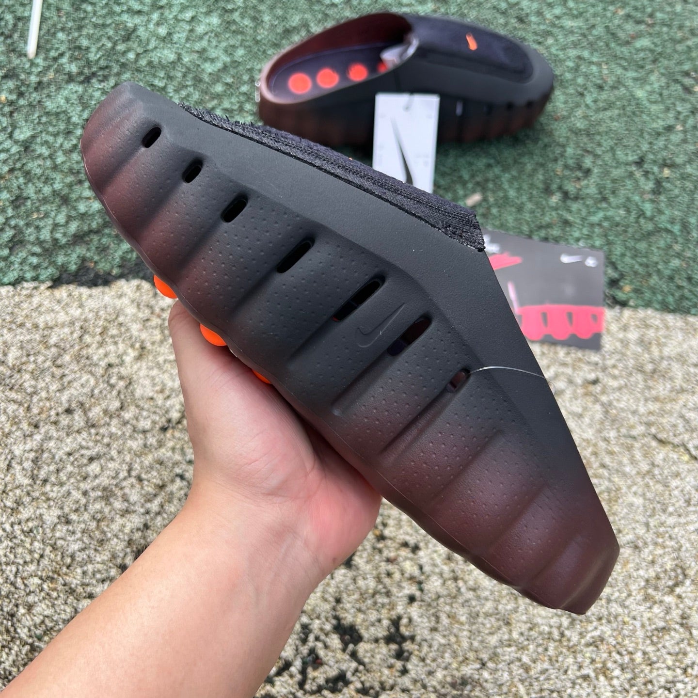 Nike x Jordan Nike Mind 001 Flyknit Slide in bronze eclipse and total orange, featuring breathable Flyknit material and sporty design.