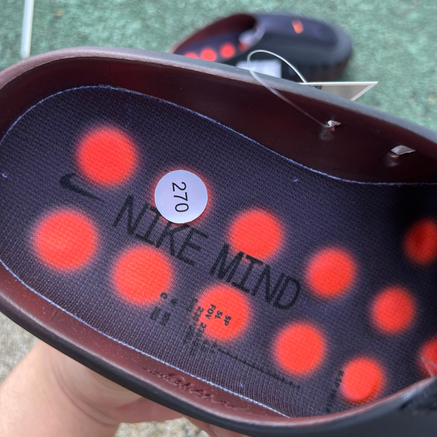 Nike x Jordan Nike Mind 001 Flyknit Slide in bronze eclipse and total orange with Nike logo on the strap
