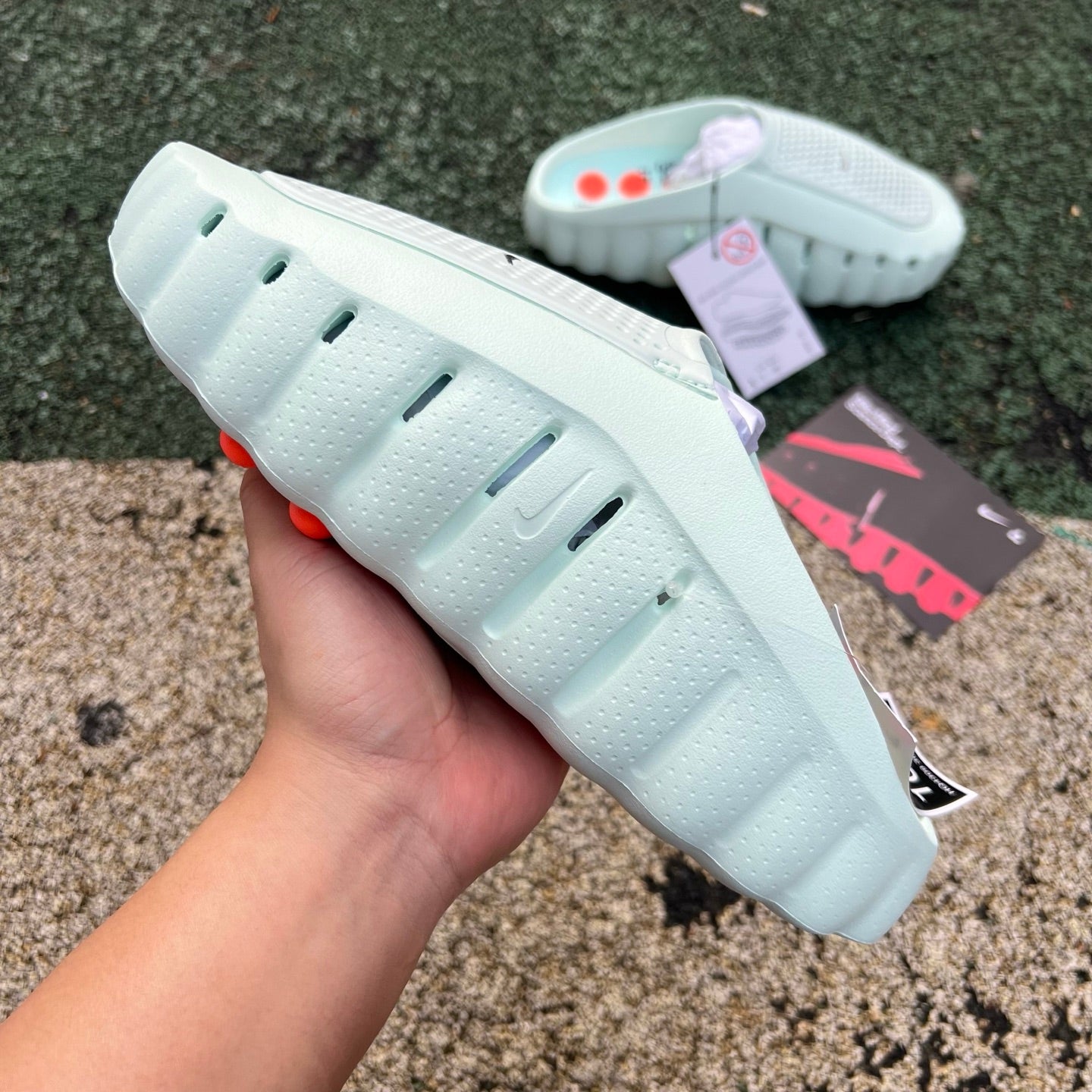 Nike x Jordan Mind 001 Slide Barely Green sandal with black strap and Nike logo, shown from side view.
