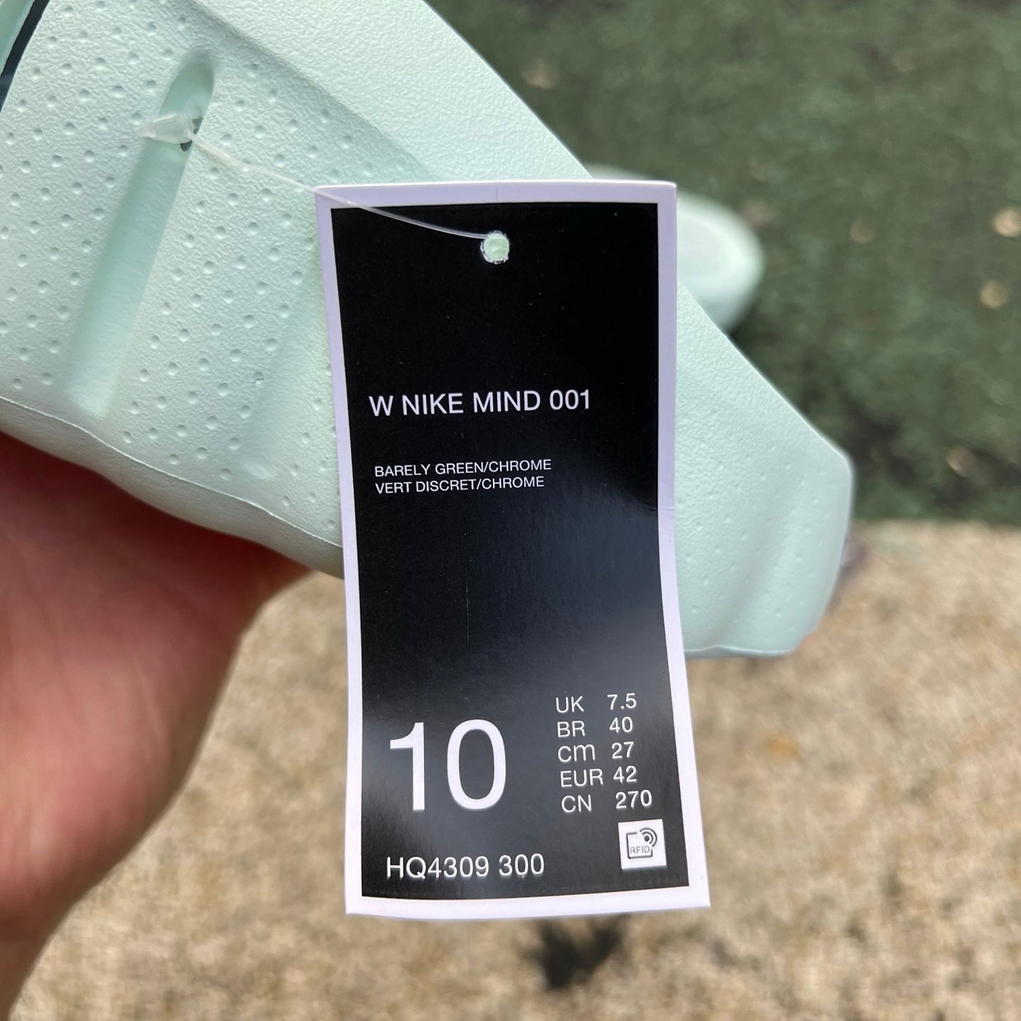 Nike x Jordan Mind 001 slide in barely green with open-toe design and cushioned sole, shown from a side angle.
