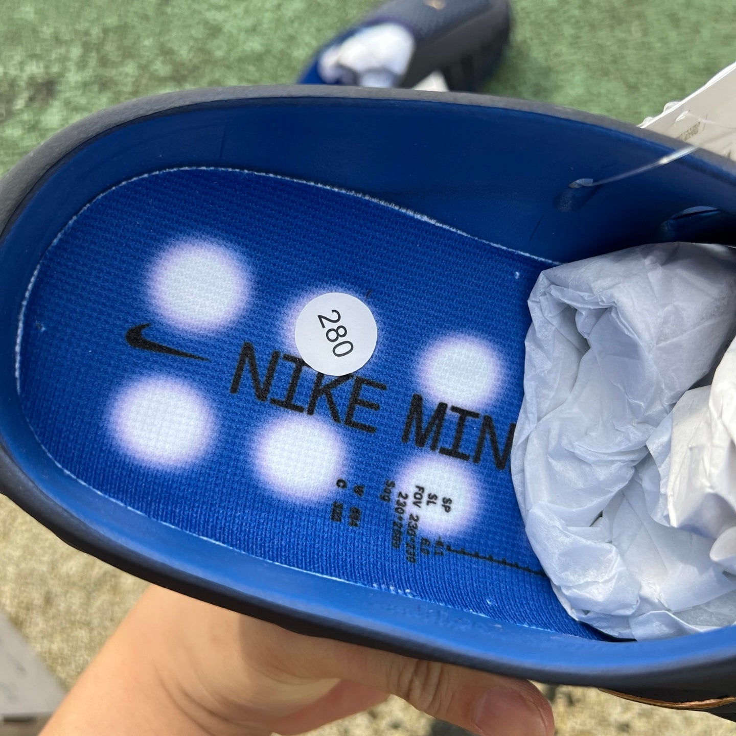 Nike Mind 001 Slide in black and blue with Nike x Jordan branding, featuring a comfortable slip-on design and textured sole.
