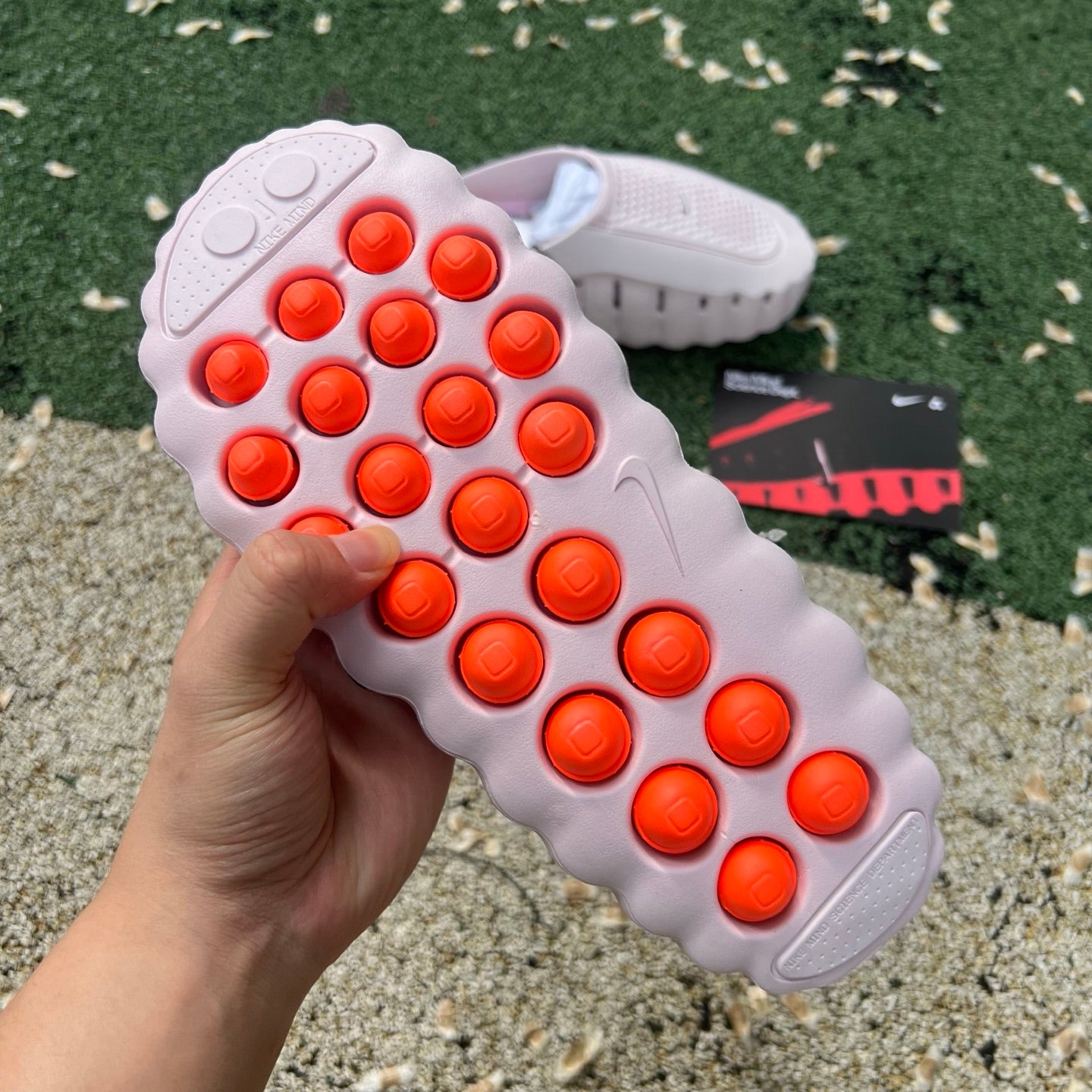 Nike x Jordan Mind 001 Pearl Pink slide sandal with cushioned strap and textured sole, designed for casual wear.