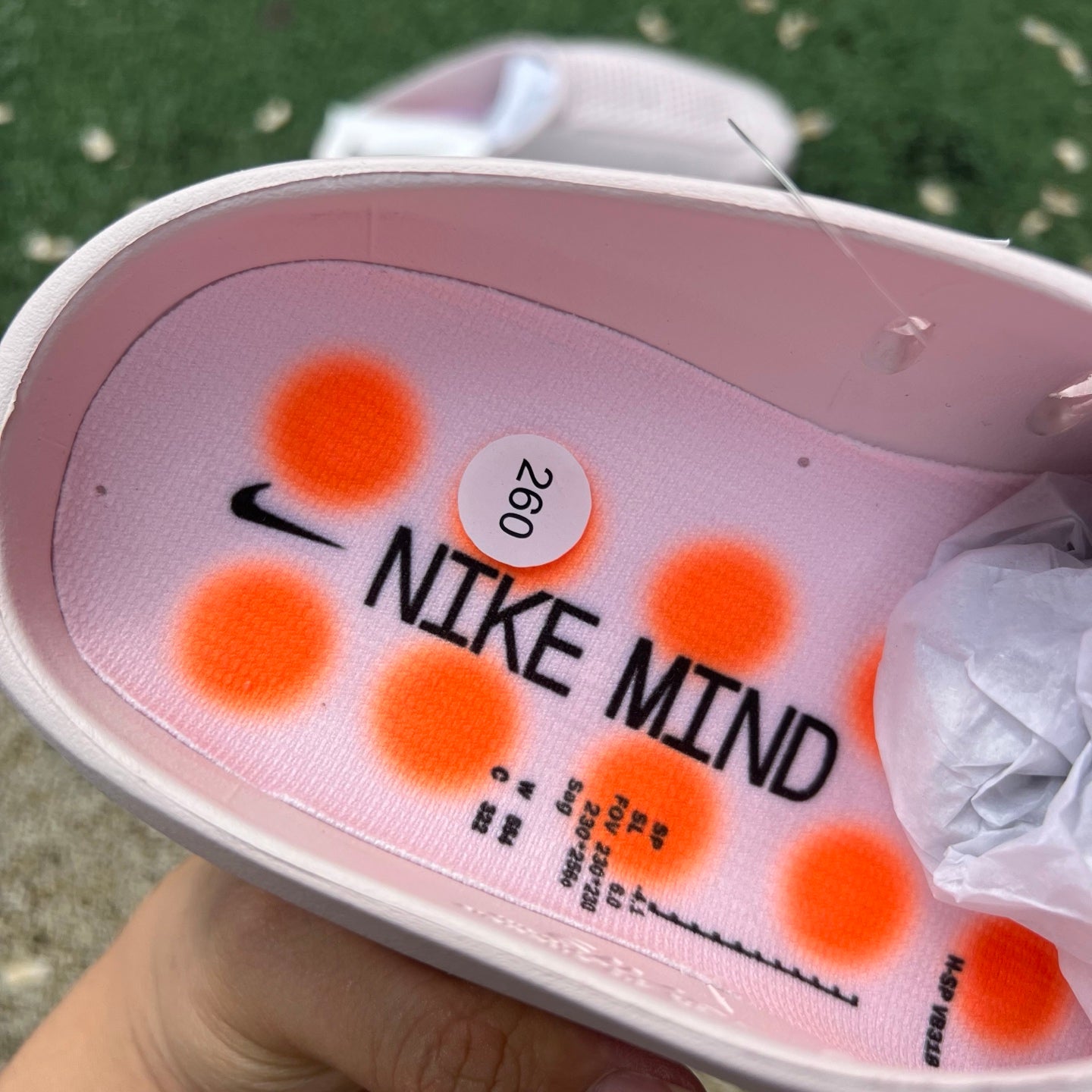 Nike x Jordan Mind 001 pink slide sandal with pearl accents, featuring a casual open-toe design and Nike branding.