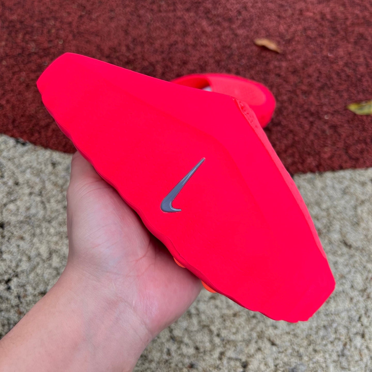 Nike x Jordan Mind 001 Solar Red slide sandal with Nike branding and cushioned strap, designed for casual wear.