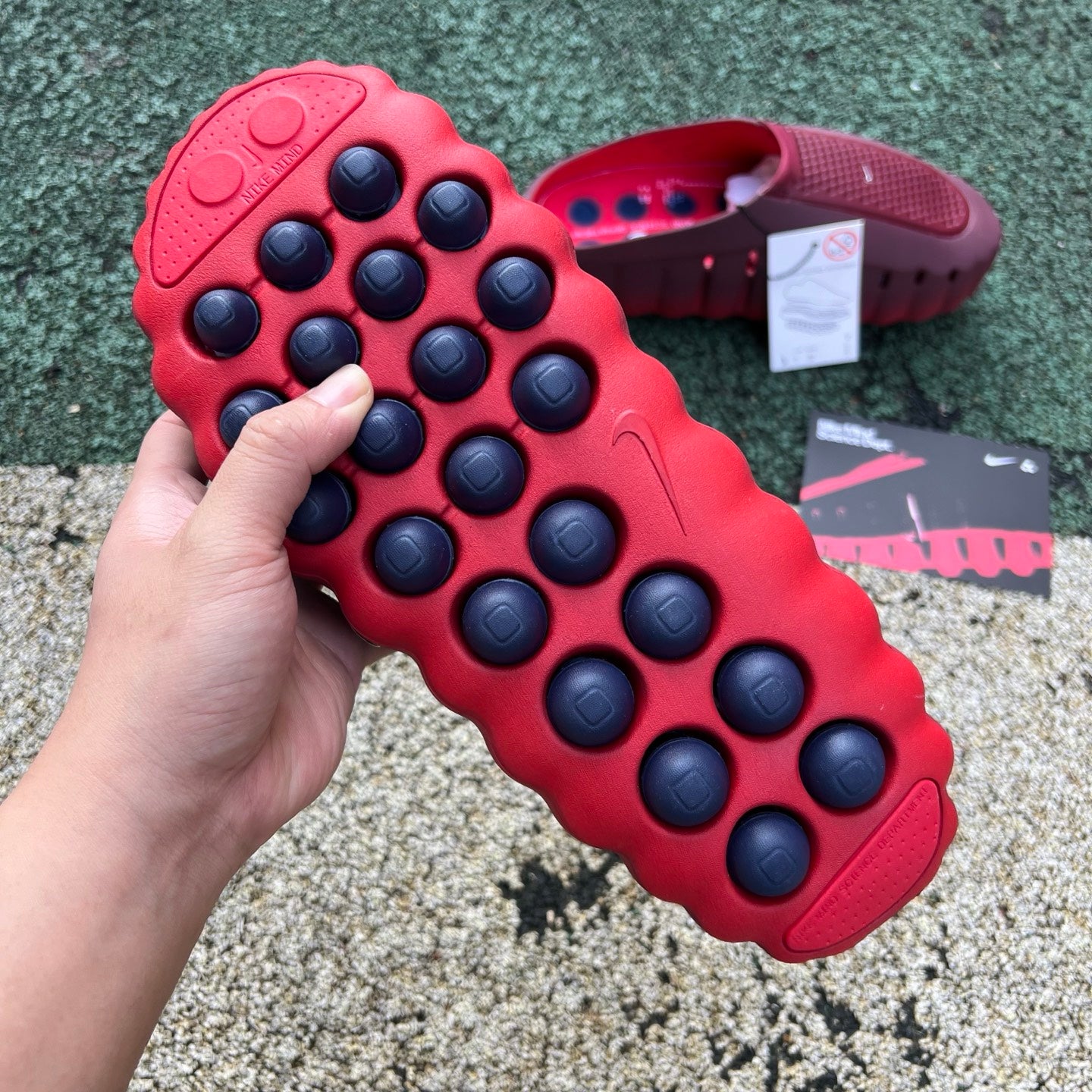 Nike Jordan Mind 001 slides in team red and university red with Nike x Jordan branding, featuring a comfortable slide design.