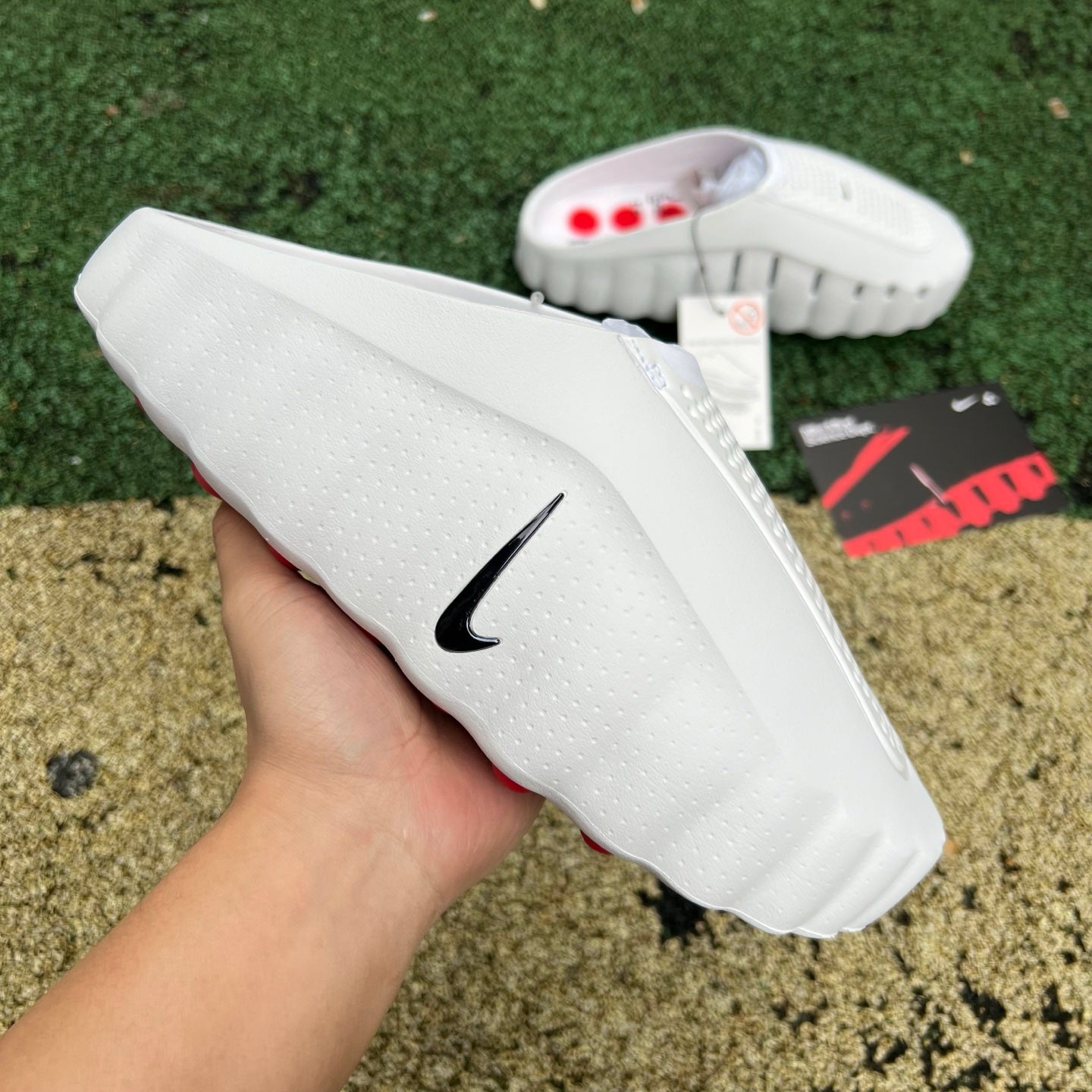 Nike x Jordan Mind 001 white and red slide sandal with Nike branding, featuring a sporty open-toe design and adjustable strap.