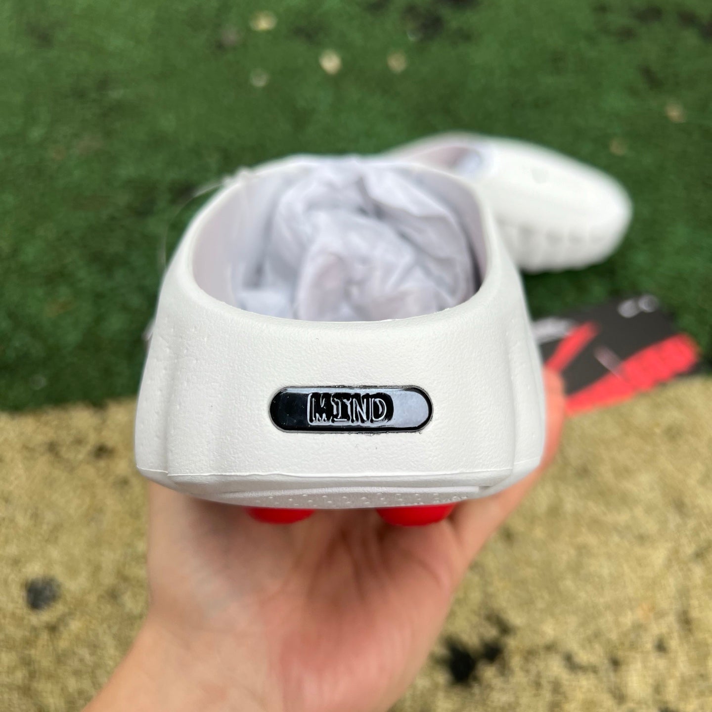 Nike x Jordan Mind 001 slide in white with red accents, featuring a comfortable open-toe design and sporty branding.