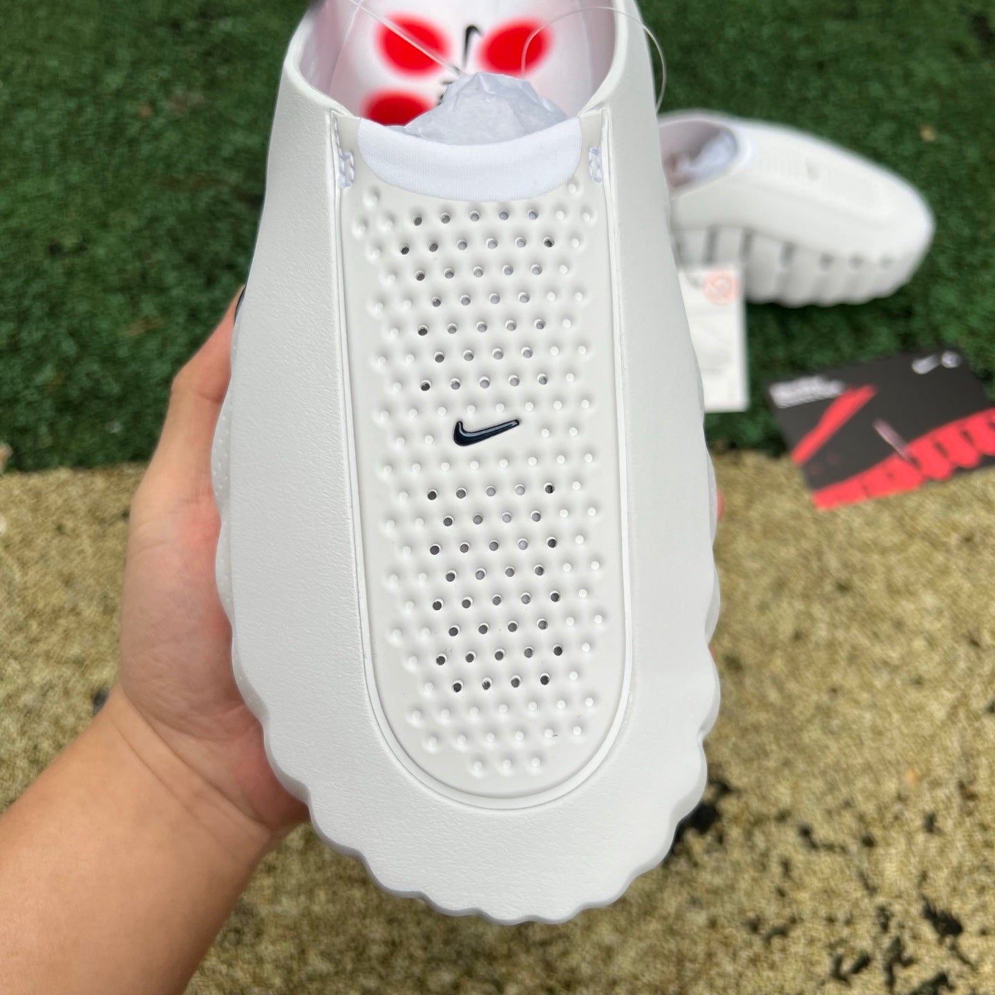 Nike x Jordan Mind 001 white and red slide sandal with Nike branding, featuring a comfortable slip-on design and bold color accents.