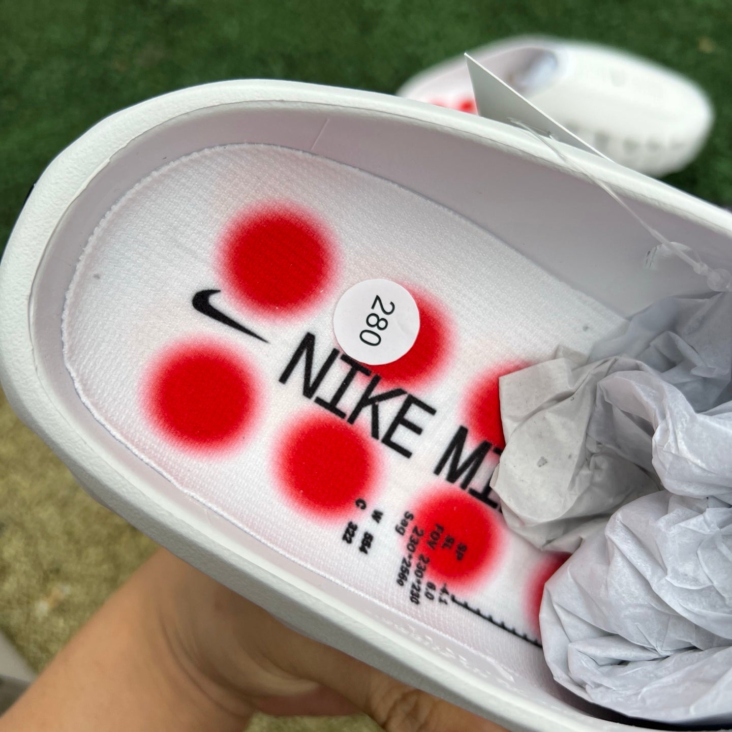 Nike x Jordan Mind 001 white slide sandal with red accents, showcasing the sporty design and branding details.