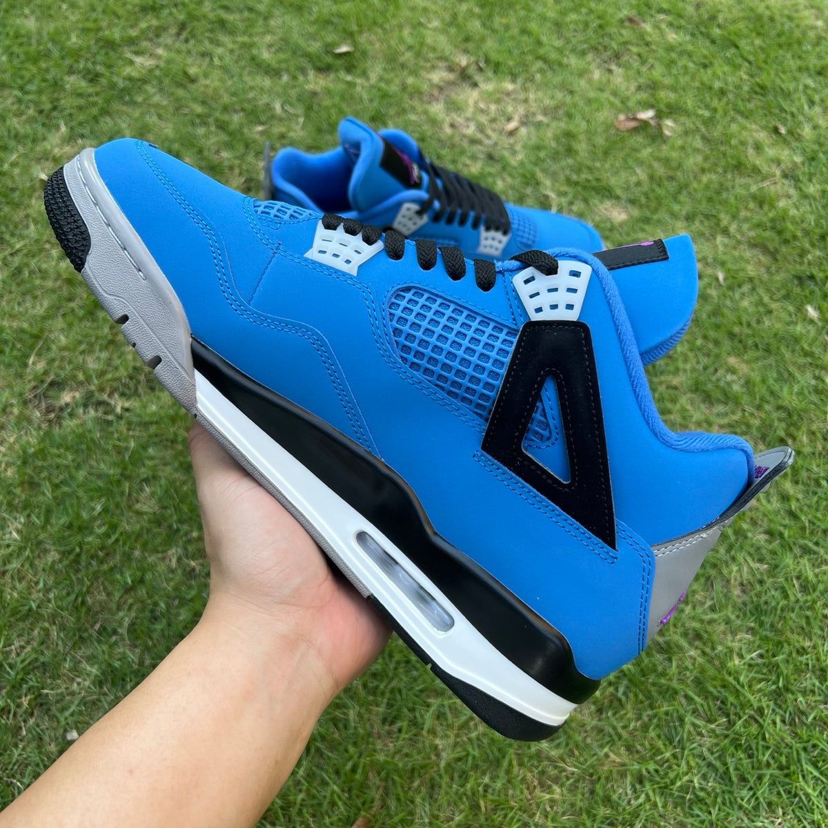 Nike x Jordan Air Jordan 4 Retro Eminem Encore sneaker showcasing white, gray, and red colorway with signature design details.