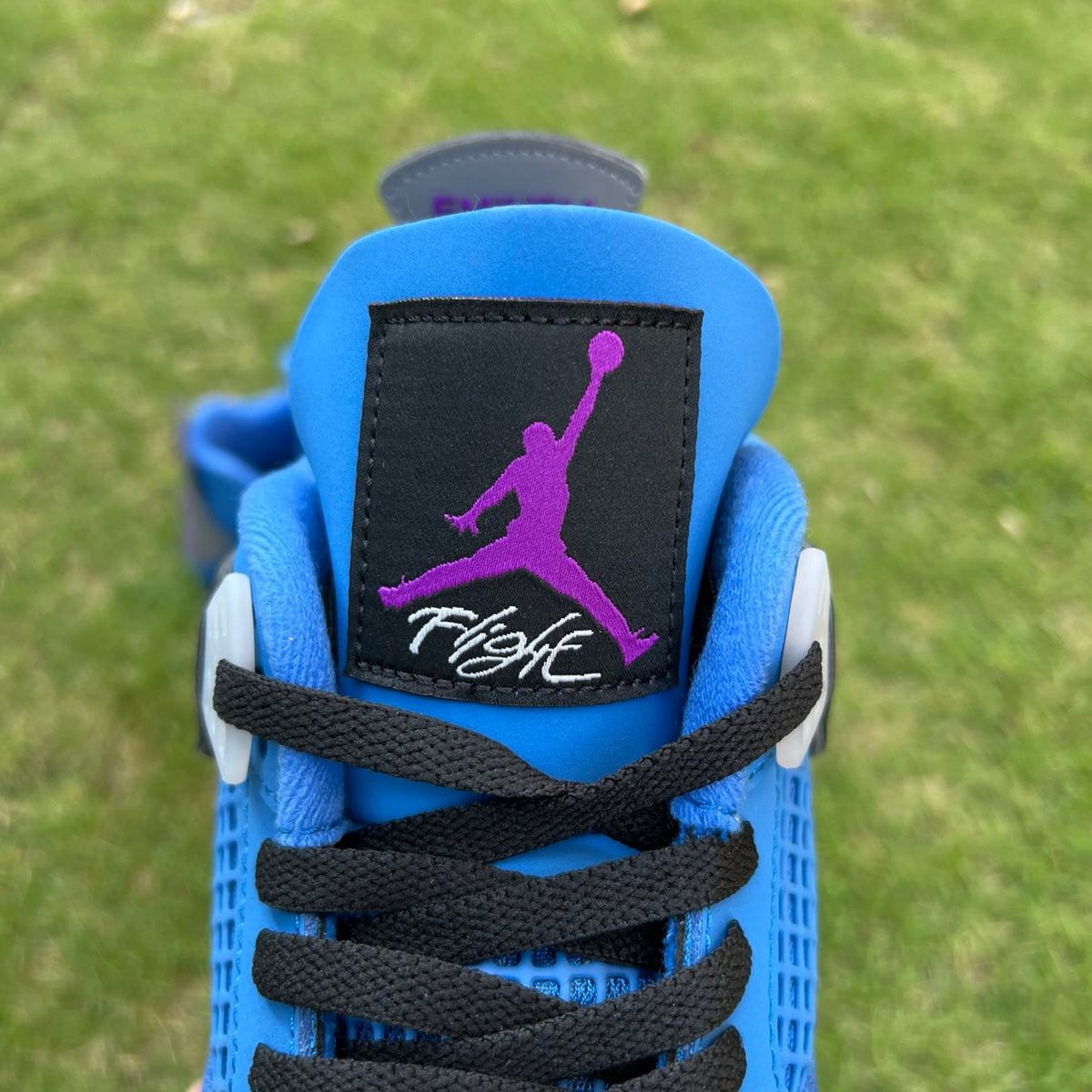 Nike Air Jordan 4 Retro Eminem Encore sneakers in black and red with detailed design elements and signature branding.