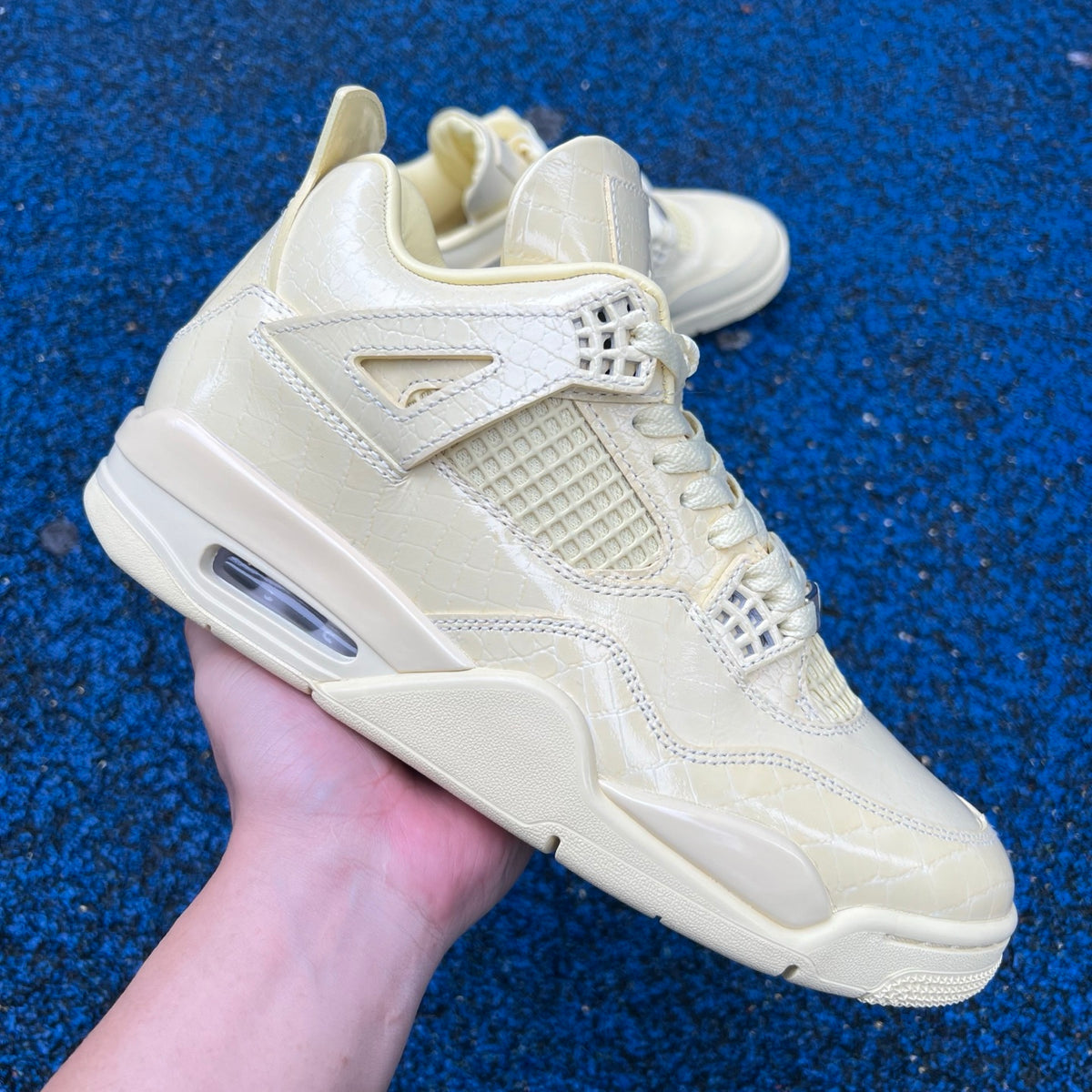 Nike Air Jordan 4 Retro J Balvin Lemonade sneakers featuring vibrant yellow and black colorway with classic basketball shoe design.
