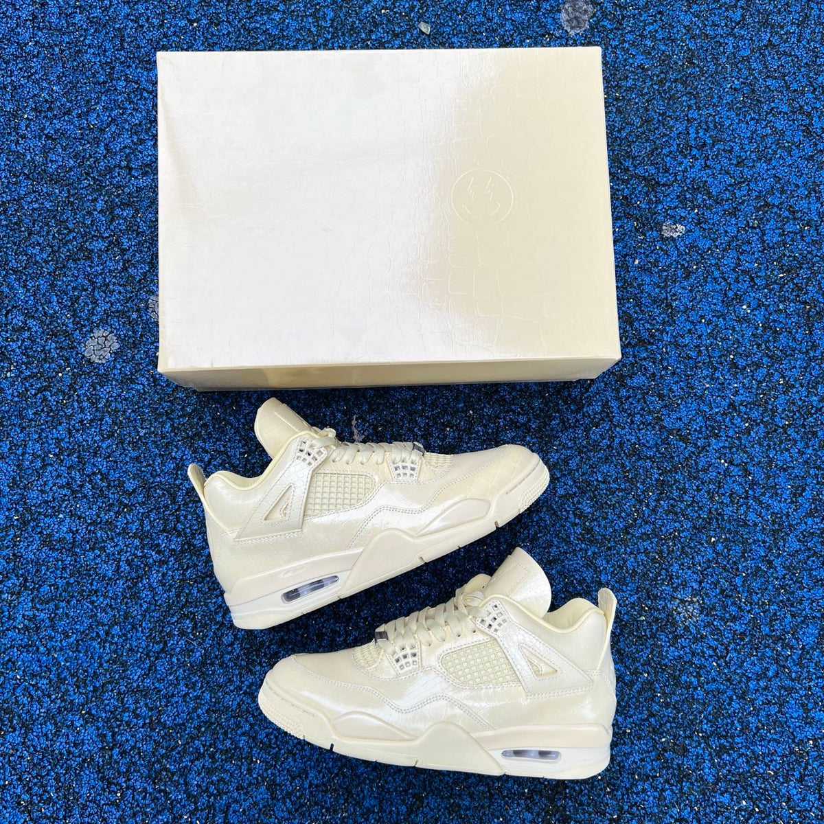 Nike Air Jordan 4 Retro J Balvin Lemonade sneakers, side view showcasing yellow and black colorway and signature design details.