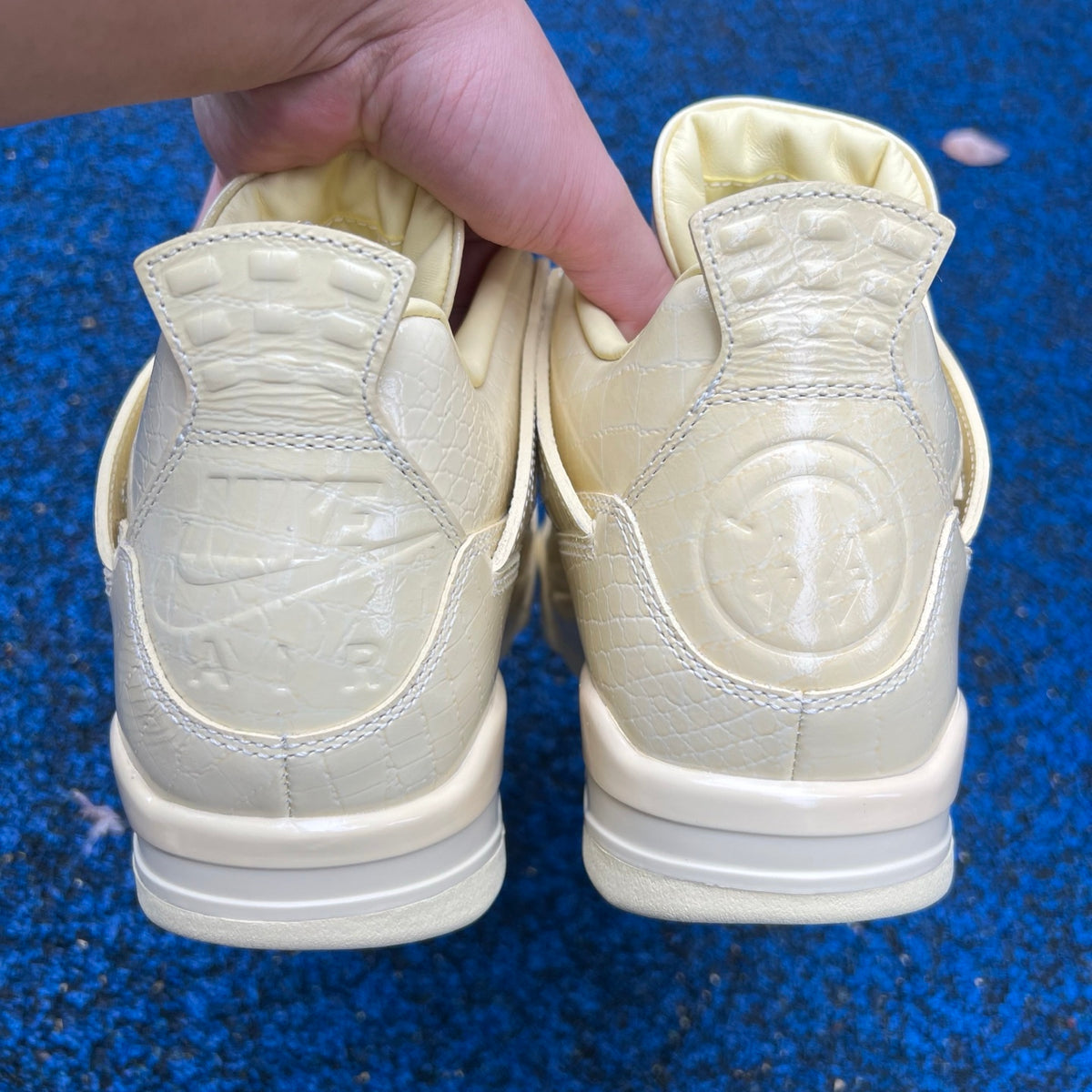Nike Air Jordan 4 Retro J Balvin Lemonade sneakers featuring yellow and black colorway, showcasing front and side views.