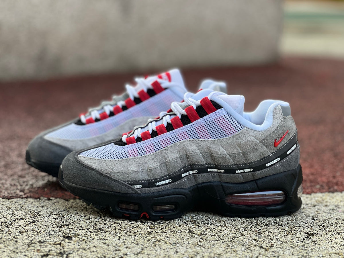 Nike Air Max 95 SP Undefeated Geo Tokyo Bright Crimson sneaker with vibrant red and geometric design, displayed on a plain background.