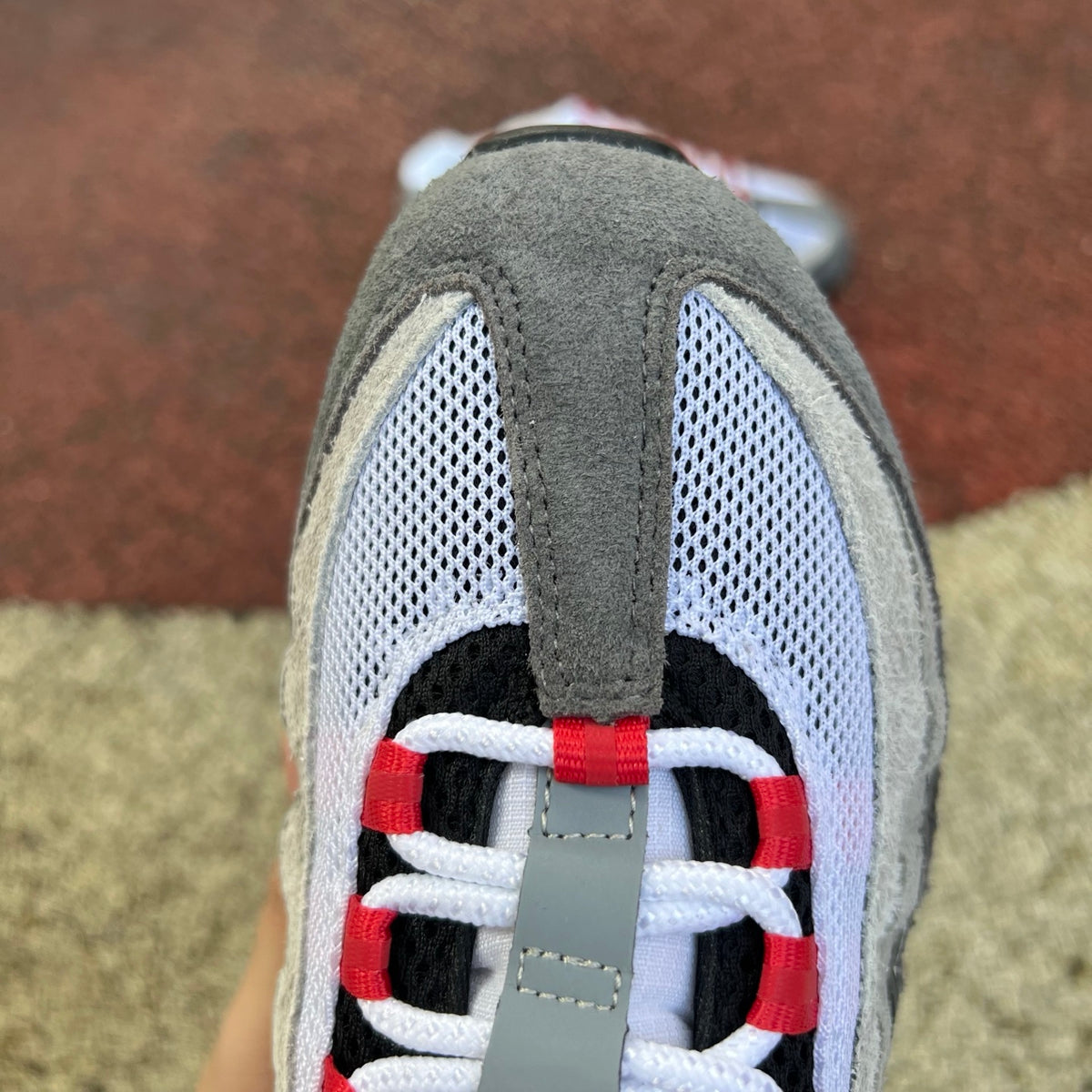 Nike Air Max 95 SP Undefeated Geo Tokyo Bright Crimson sneaker in close-up, showcasing the vibrant red and detailed design.