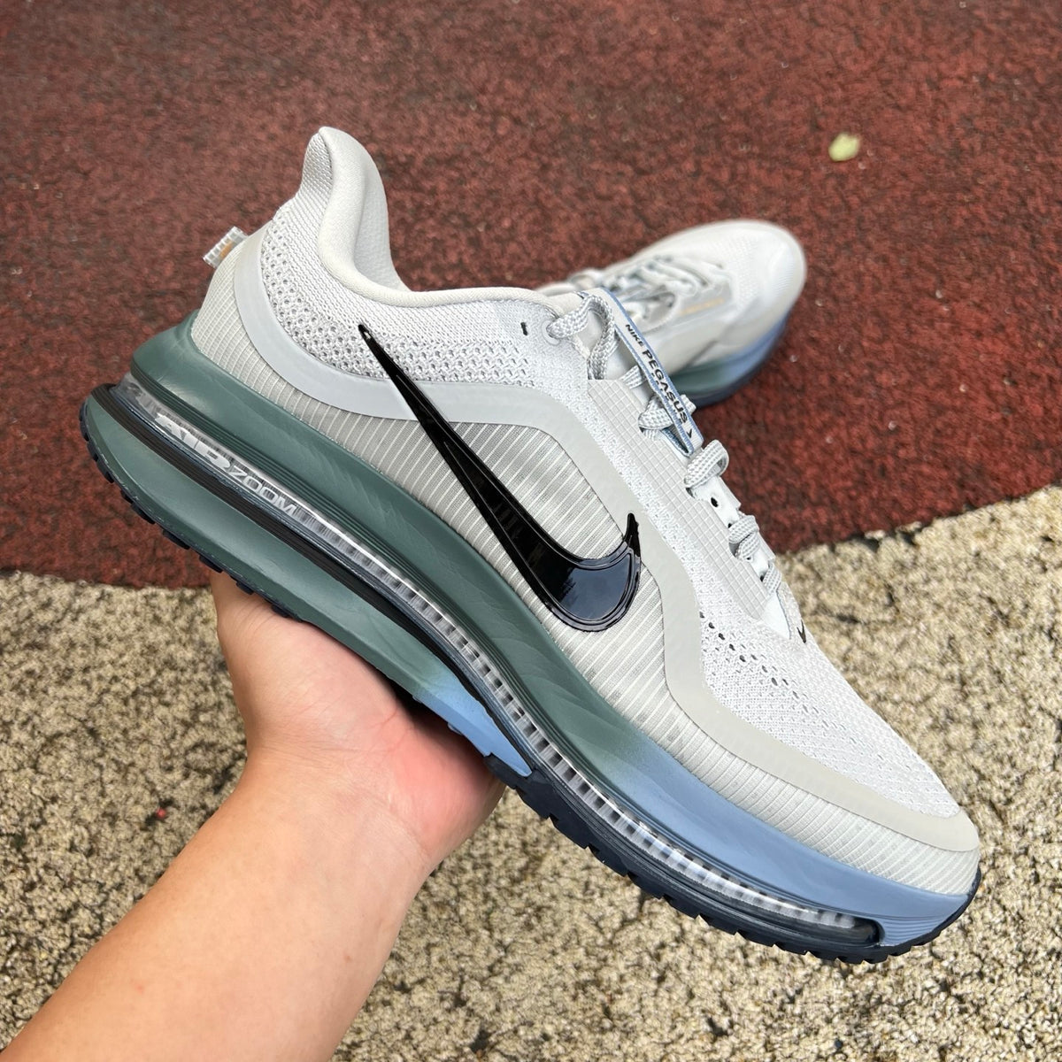 Nike Air Zoom Pegasus running shoes in grey mist, mineral slate, and dark obsidian with Nike x Jordan branding, shown from the side.