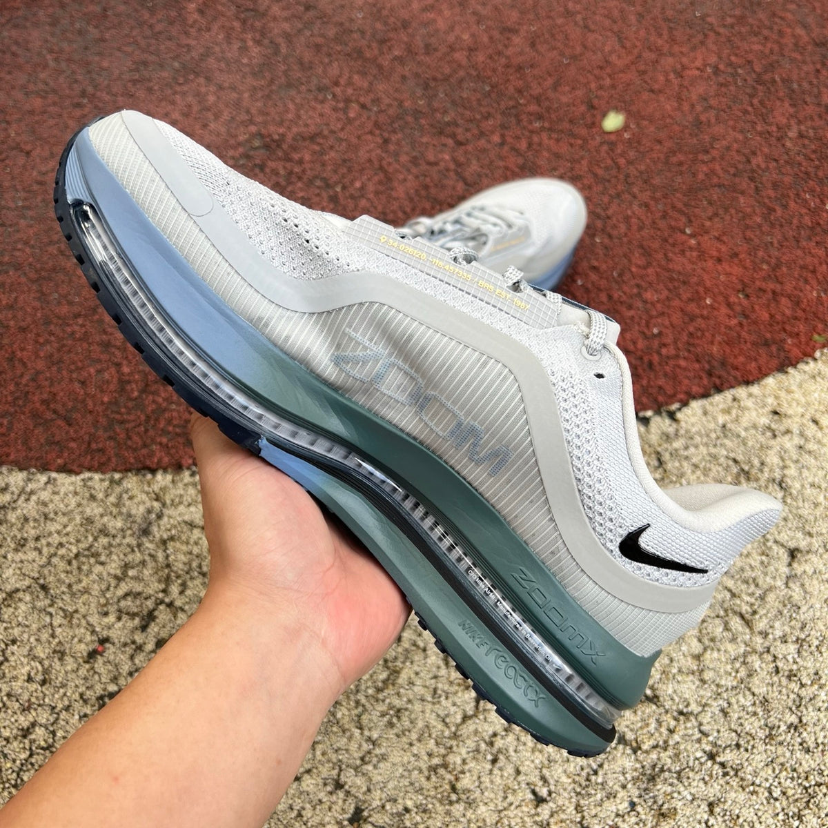 Nike Air Zoom Pegasus running shoes in grey mist, mineral slate, and dark obsidian with Nike x Jordan branding, front view.