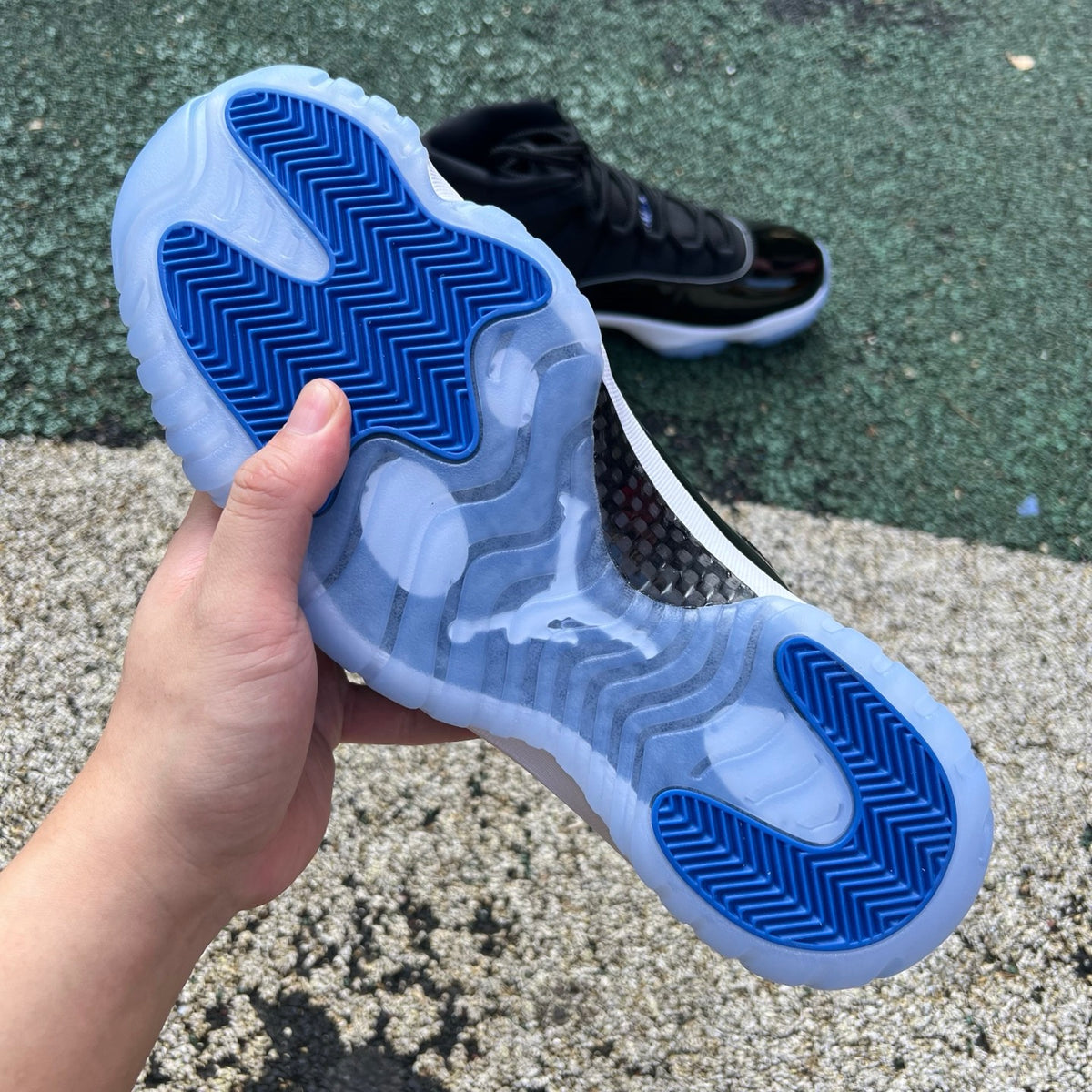 Nike Air Jordan 11 Retro Space Jam sneakers in black with patent leather, featuring iconic design details and translucent outsole.