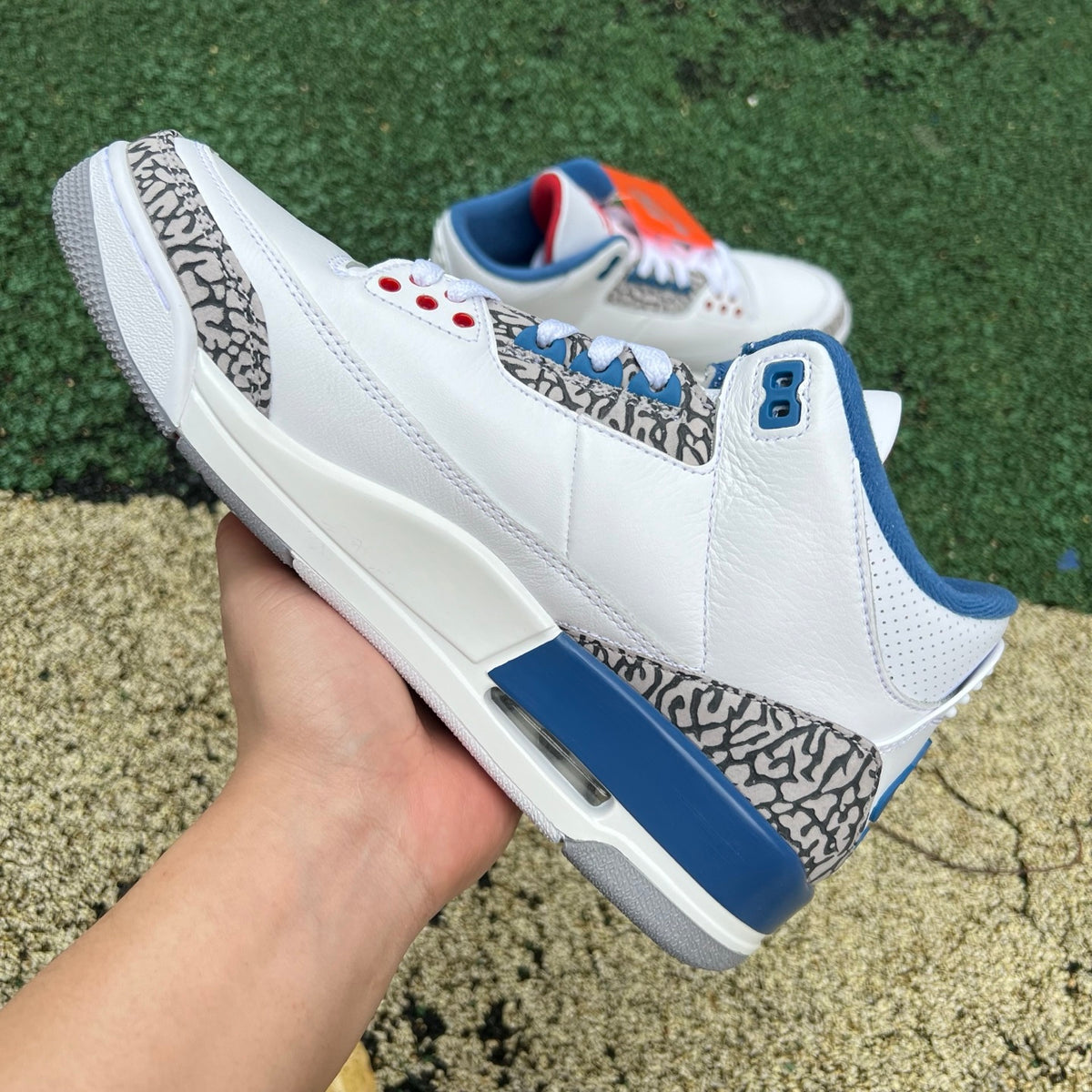 Nike Air Jordan 3 Retro True Blue sneakers by Nike x Jordan with white, blue, and gray colorway, close-up of the side and sole.