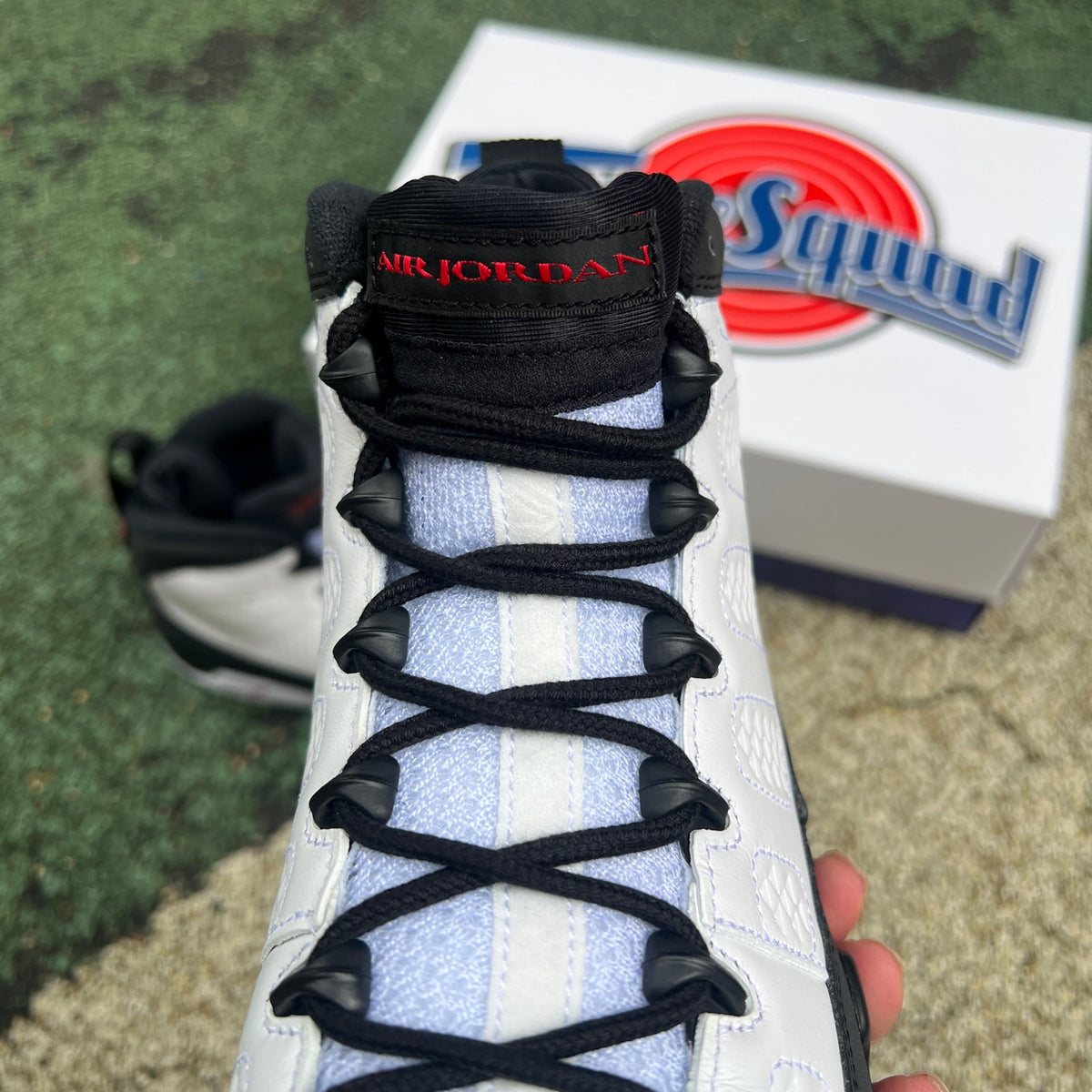 Nike Air Jordan 9 Retro OG Space Jam sneakers in black, blue, and white with signature Jumpman logo and space-themed design.