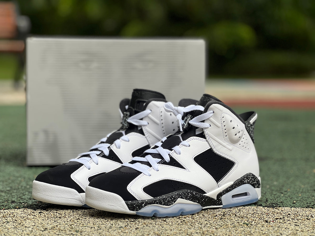 Nike Air Jordan 6 Retro Oreo sneakers in black and white with a sleek design and visible Air cushioning, front view.