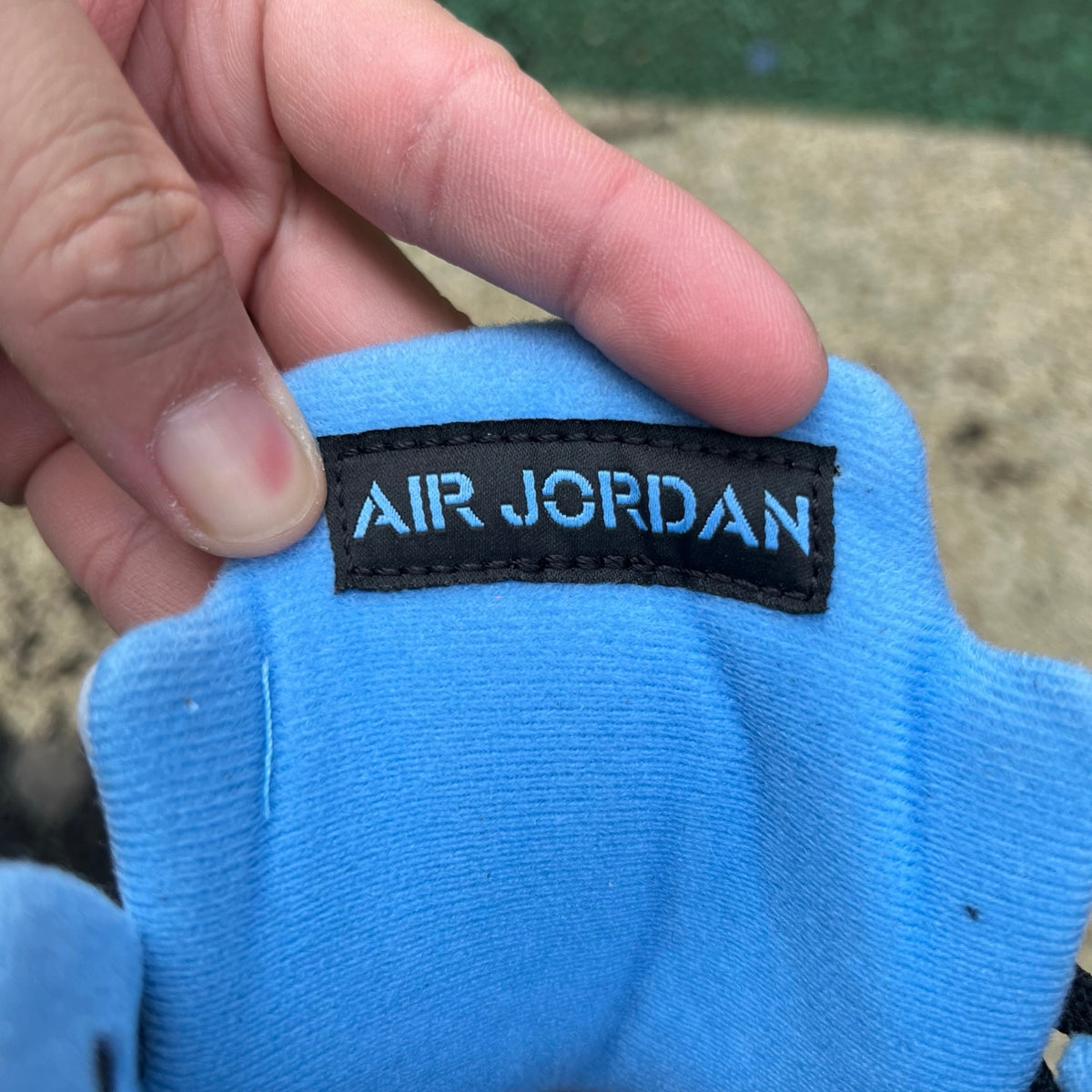 Nike Air Jordan 5 Retro sneakers in black and university blue, featuring a sleek design and iconic style.