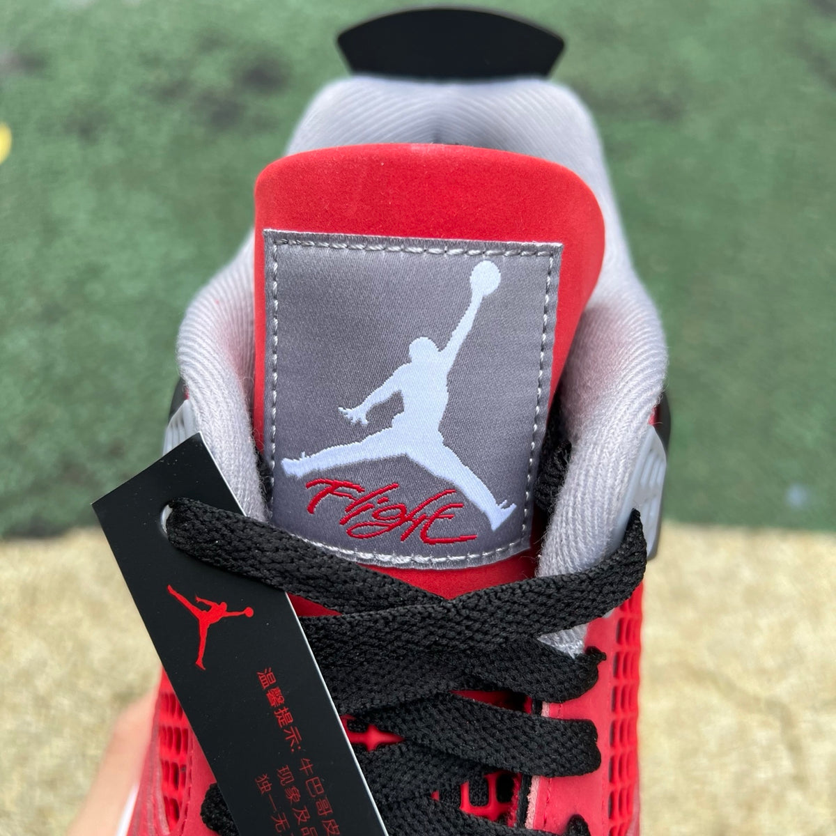 Nike Air Jordan 4 Retro Toro Bravo sneakers in red and black with white accents, featuring signature design elements.