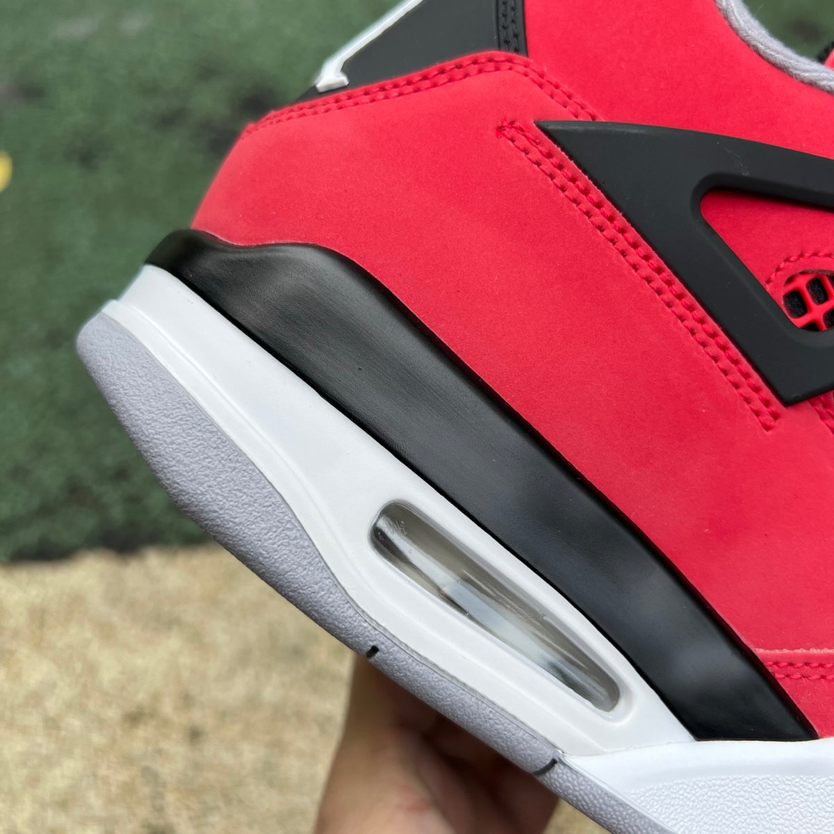 Nike Air Jordan 4 Retro Toro Bravo sneakers in red and black with white accents, showcasing the iconic design and premium materials.