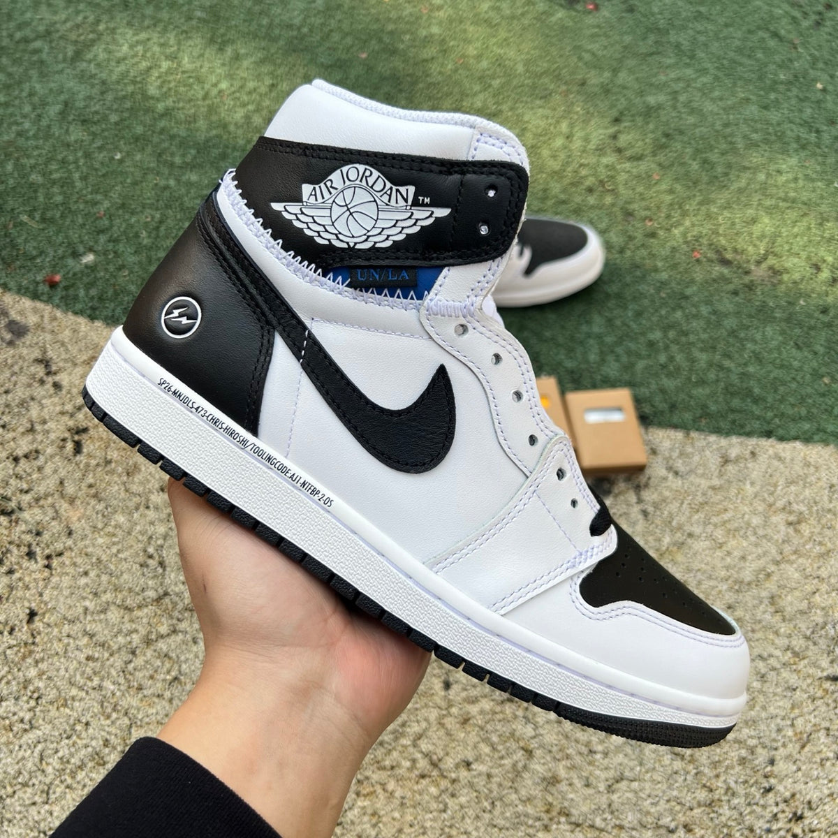 Nike Air Jordan 1 Retro High OG SP Fragment x Union LA sneakers in white and black, featuring high-top design and classic branding.