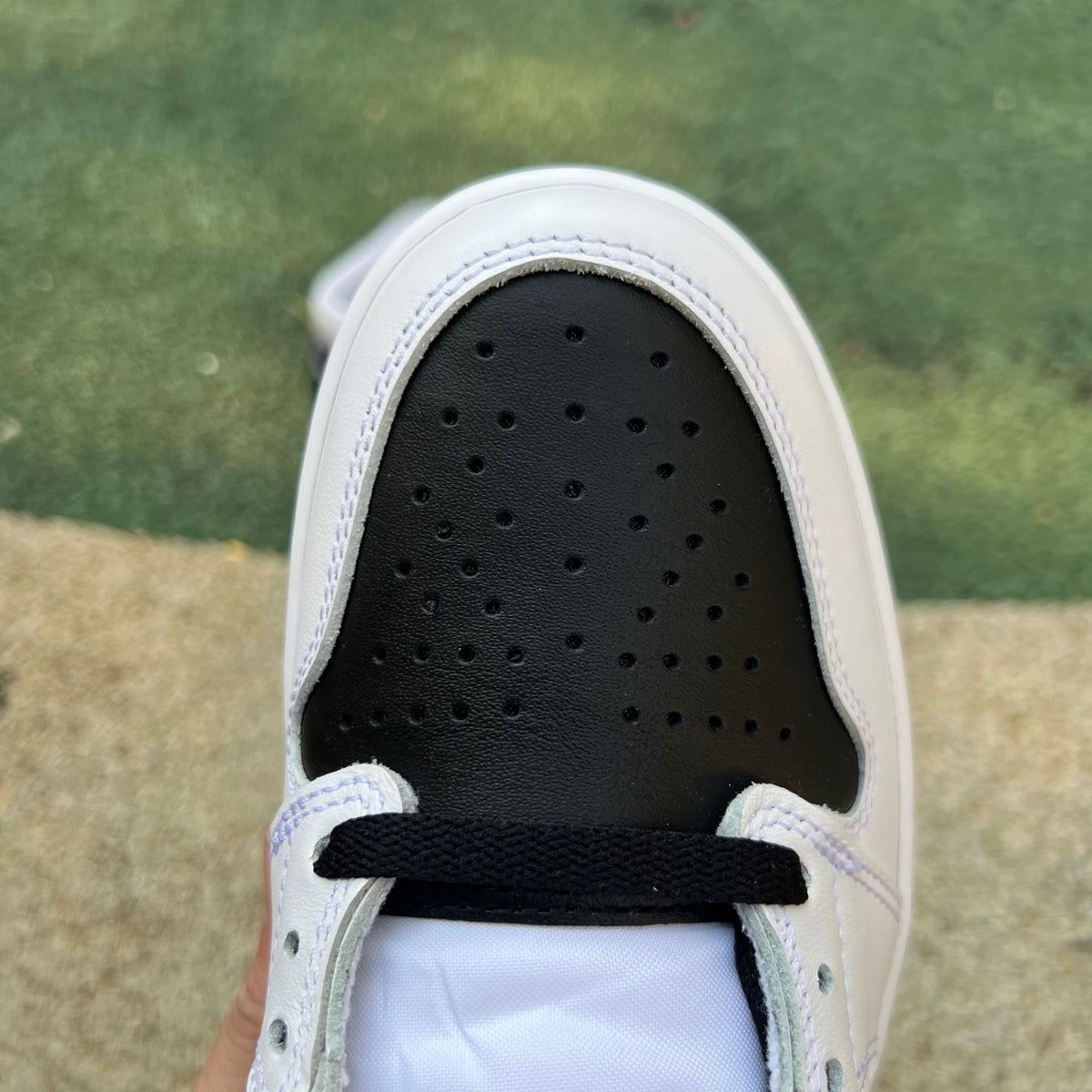 Nike Air Jordan 1 Retro High OG SP Fragment x Union LA sneakers in white and black, featuring high-top design and iconic branding.